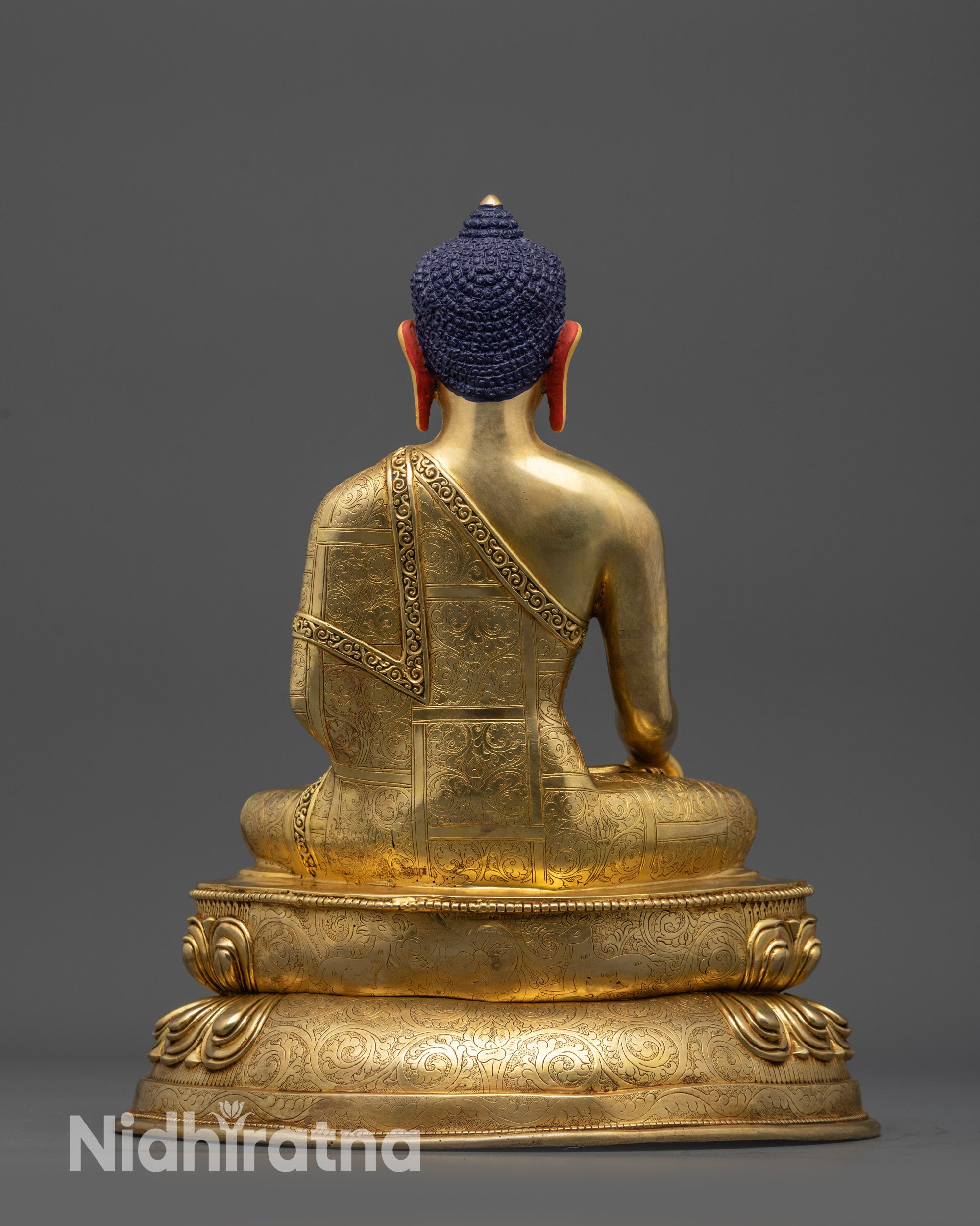Back view of Meditating Shakyamuni Buddha statue with carved robe patterns and lotus base