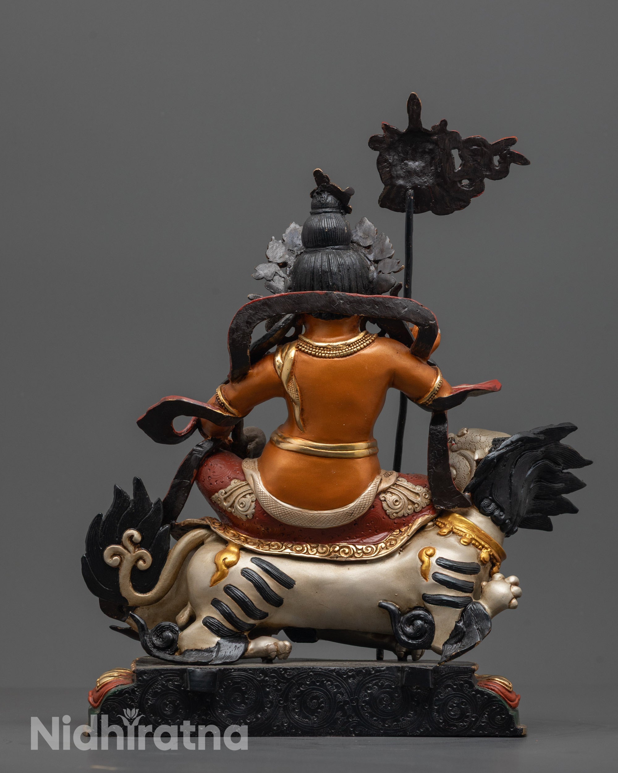 Back view of Namtoshe Sculpture highlighting swirling robe and radiant carved halo