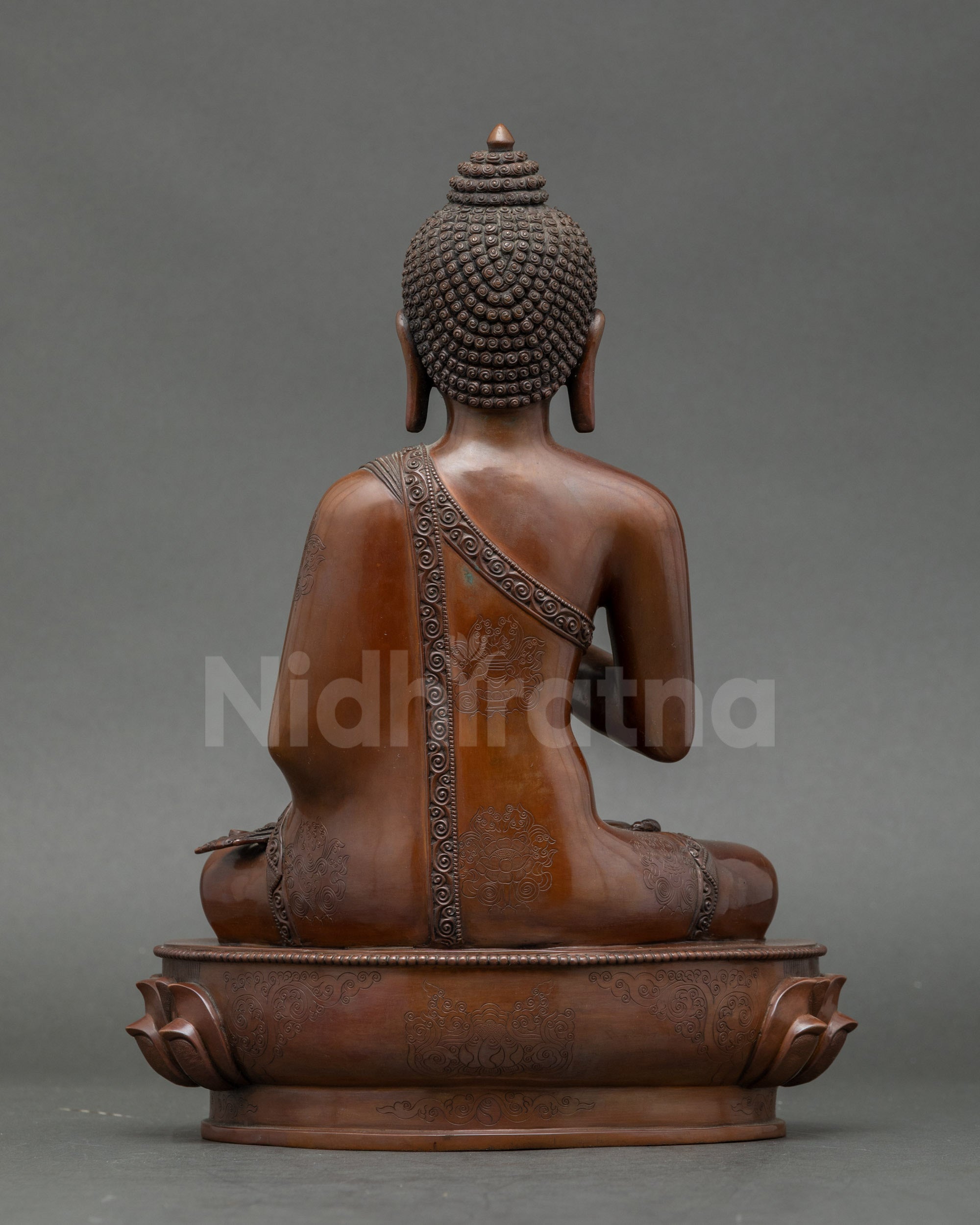 Back view of Nepalese Amoghasiddhi Buddha sculpture, detailed gold-gilded art
