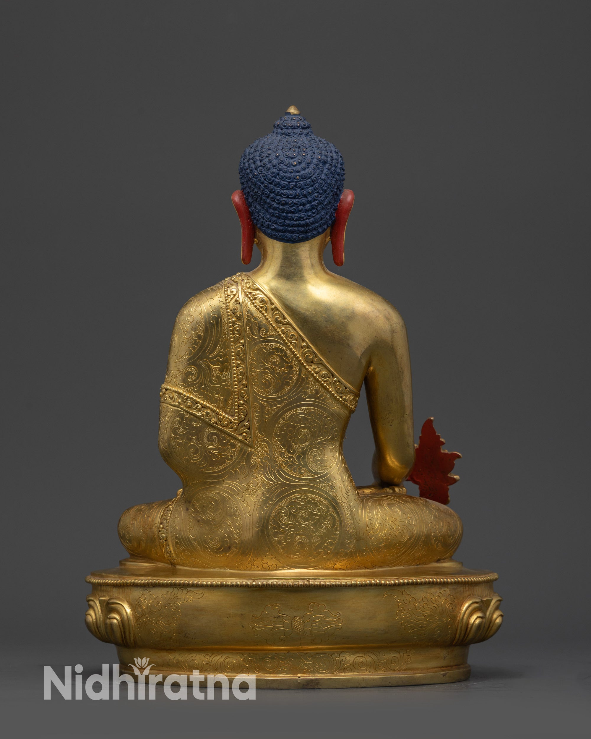 Back view of Nepalese Medicine Buddha Statue with dharma wheel and deer details