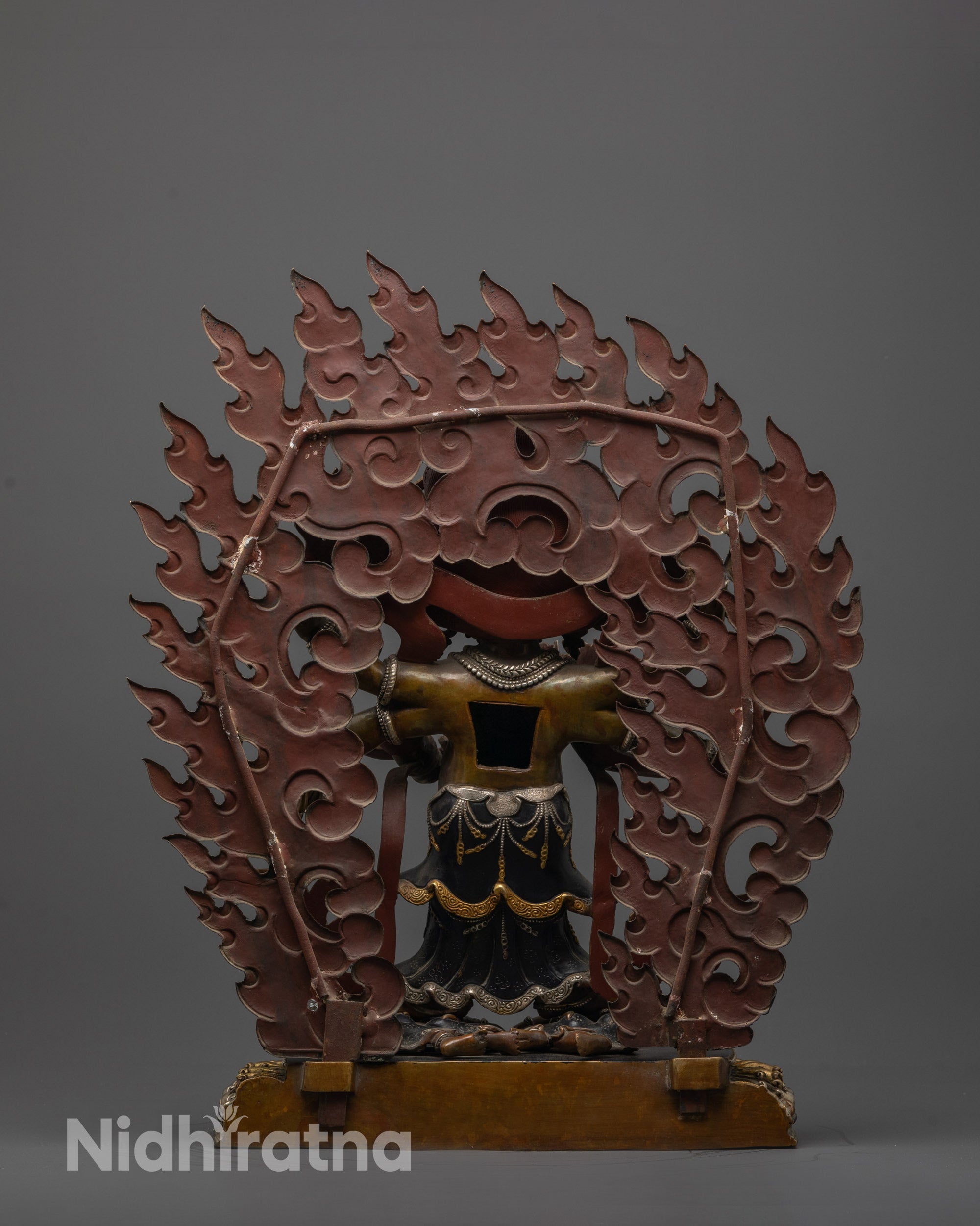 Back view of Oxidized Mahakala statue highlighting blackened halo and intricate lower garments