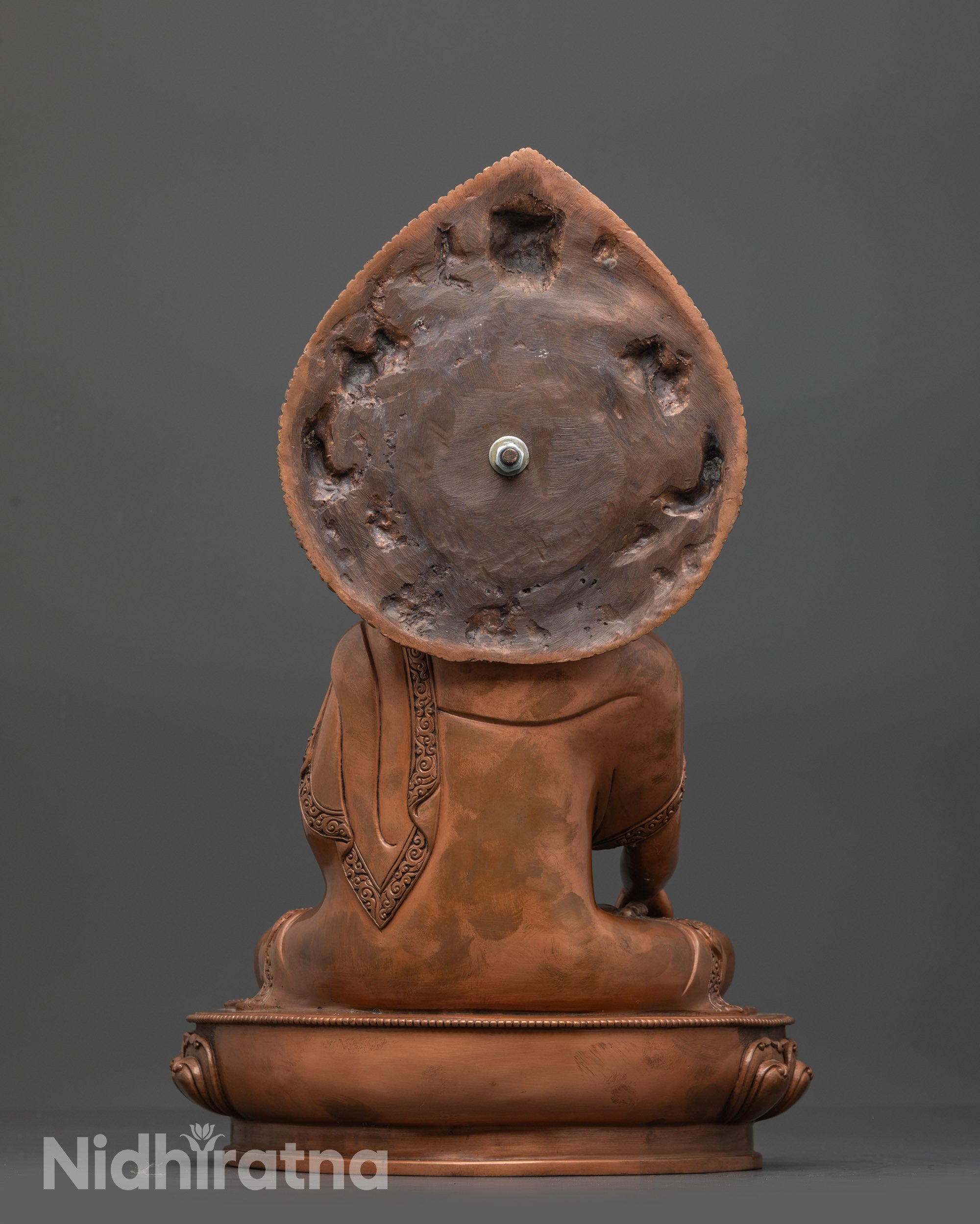 Back view of Oxidized Shakyamuni Buddha Statue highlighting robe folds and miniature Garuda head