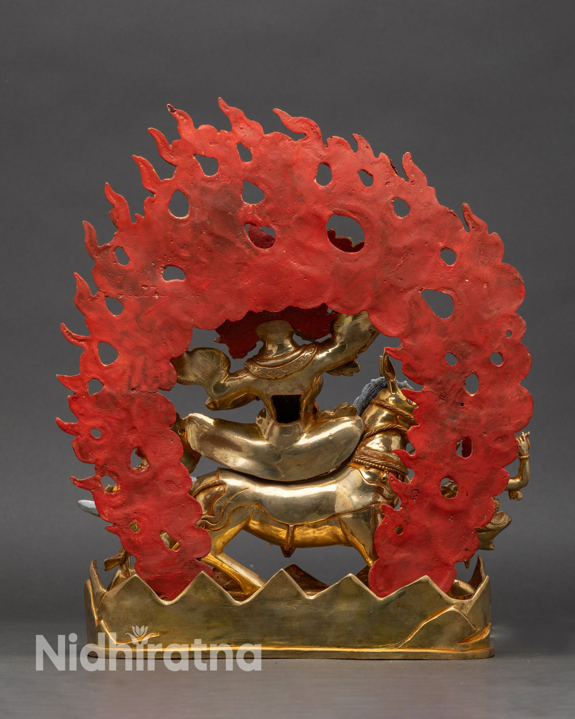 Back view of Palden Lhamo Riding Mule Statue, displaying flaming halo and attendants