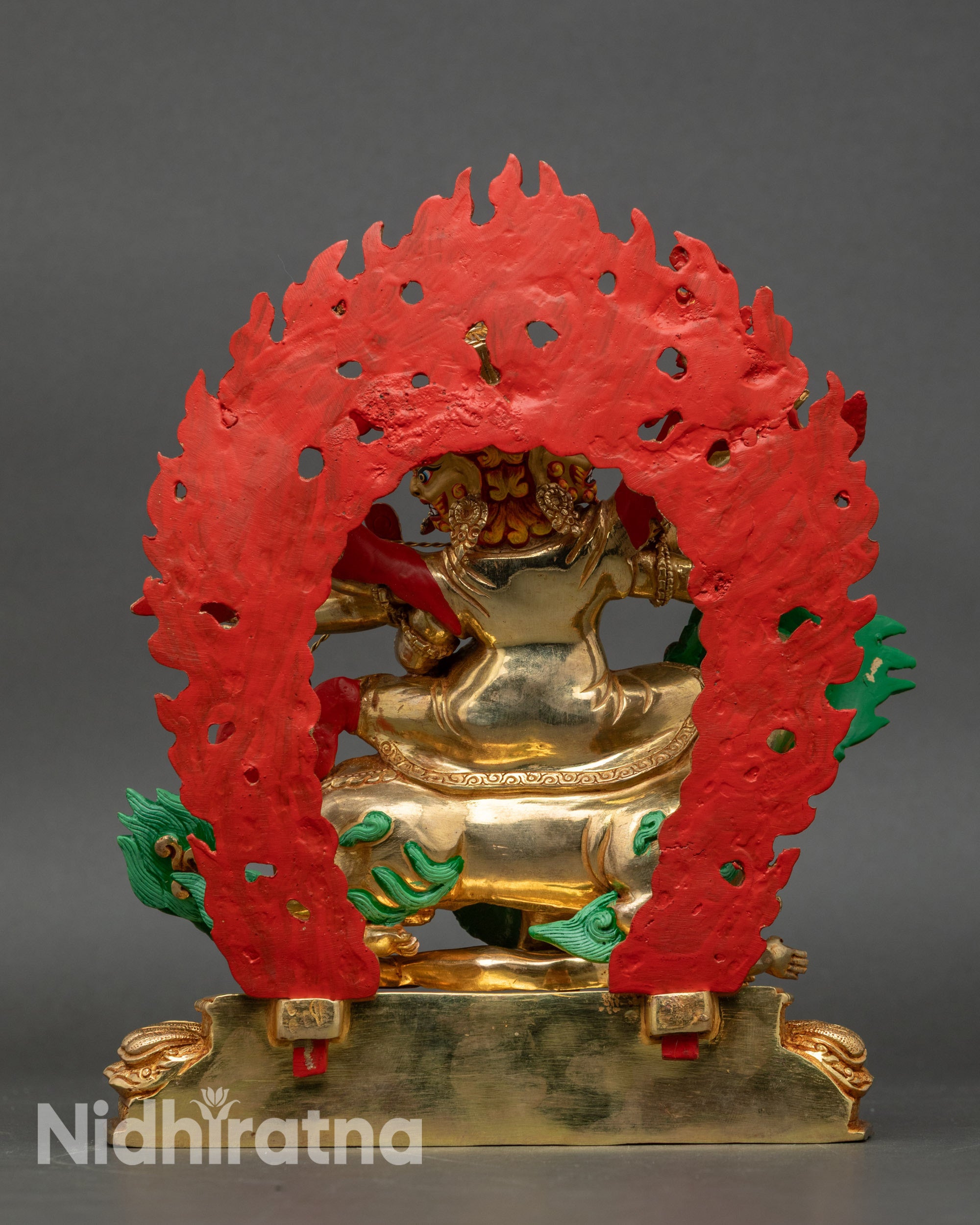Back view of Pehar Gyalpo statue showing robe details and radiant fire halo