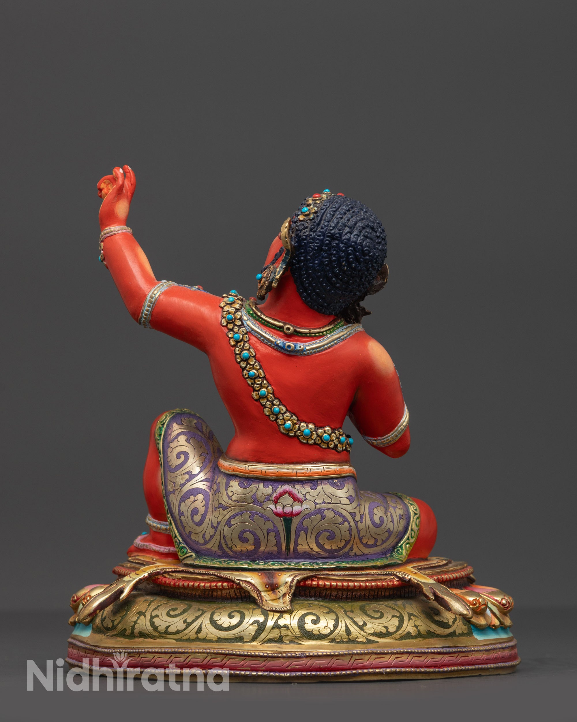 Back view of Red Hued Virupa Sculpture highlighting intricate carvings and vibrant colors
