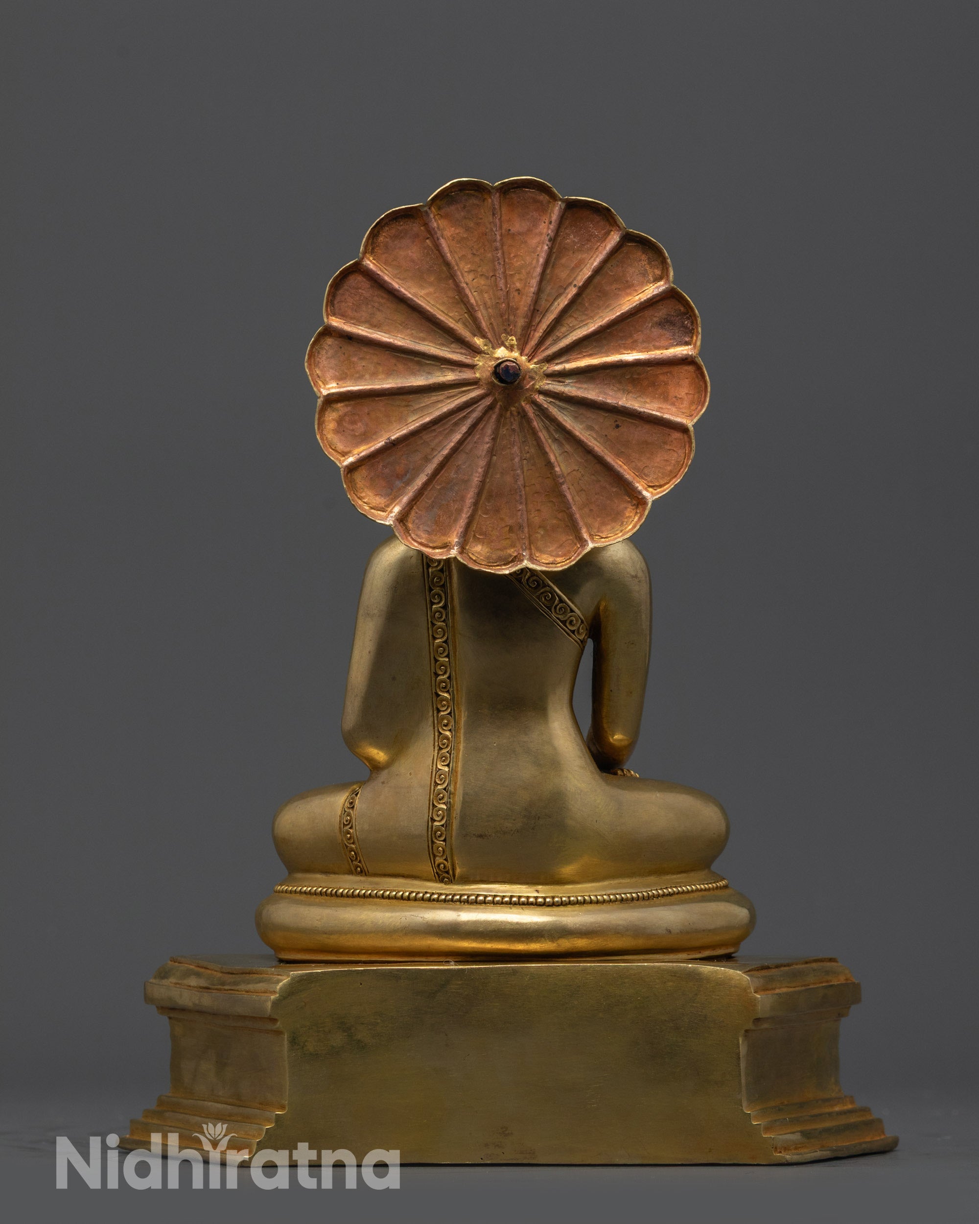 Back view of Sacred Buddha Sculpture highlighting detailed carvings on robe and halo
