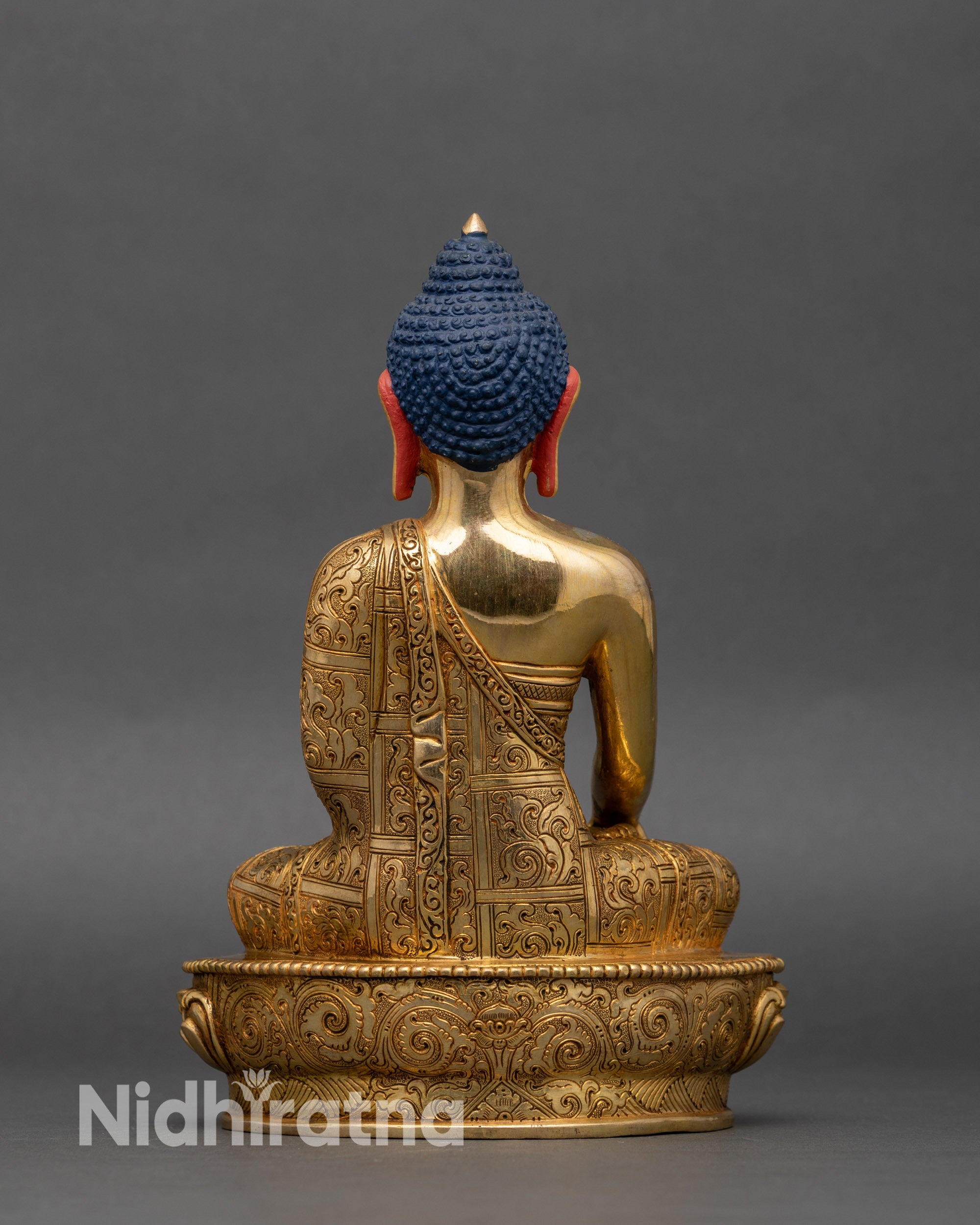 Back view of Shakyamuni Buddha, showing lotus pedestal and carved monastic robes
