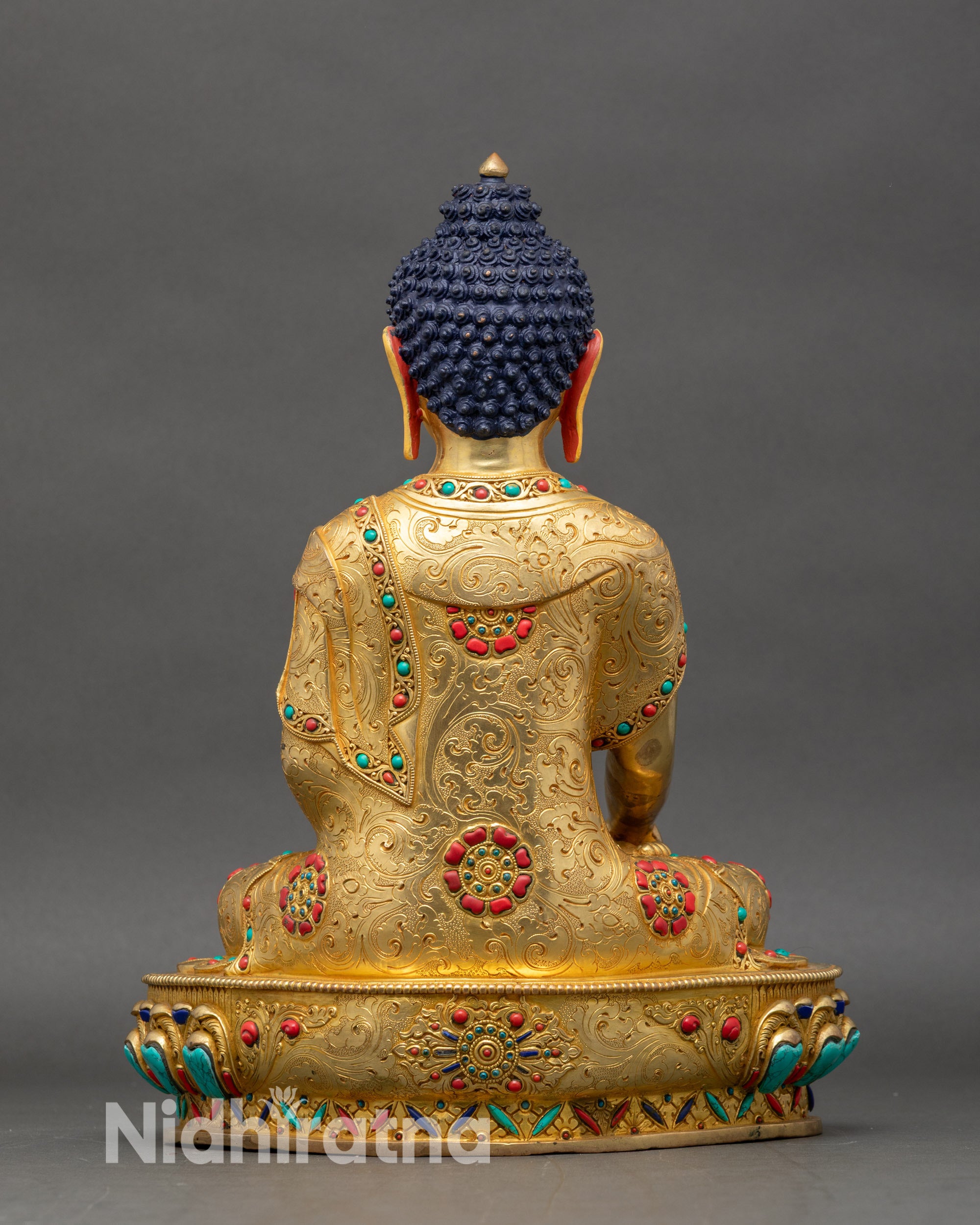 Back view of Shakyamuni Buddha statue, carved lotus seat with Himalayan decorative details