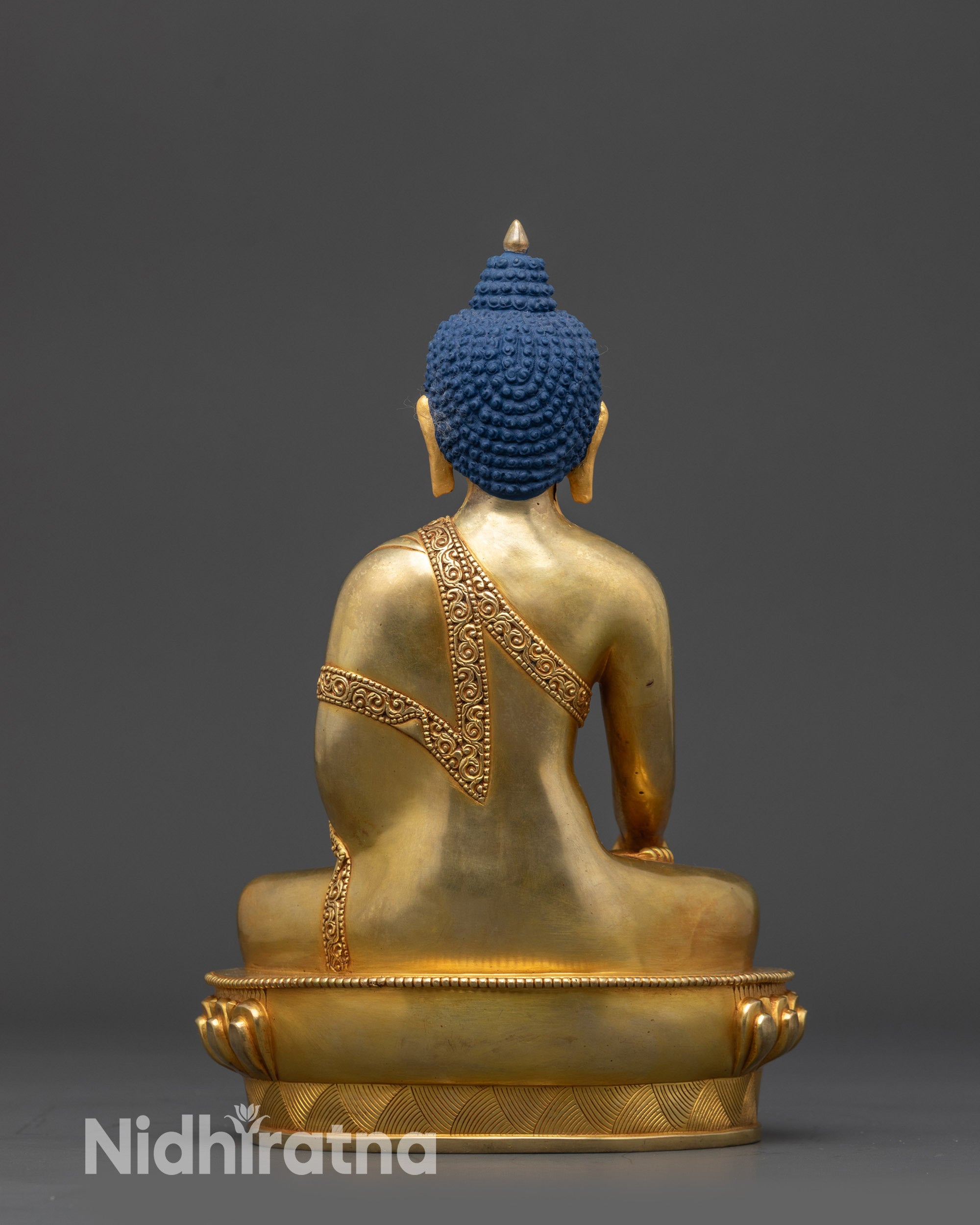 Back view of Shakyamuni Buddha statue highlighting robe carvings and craftsmanship