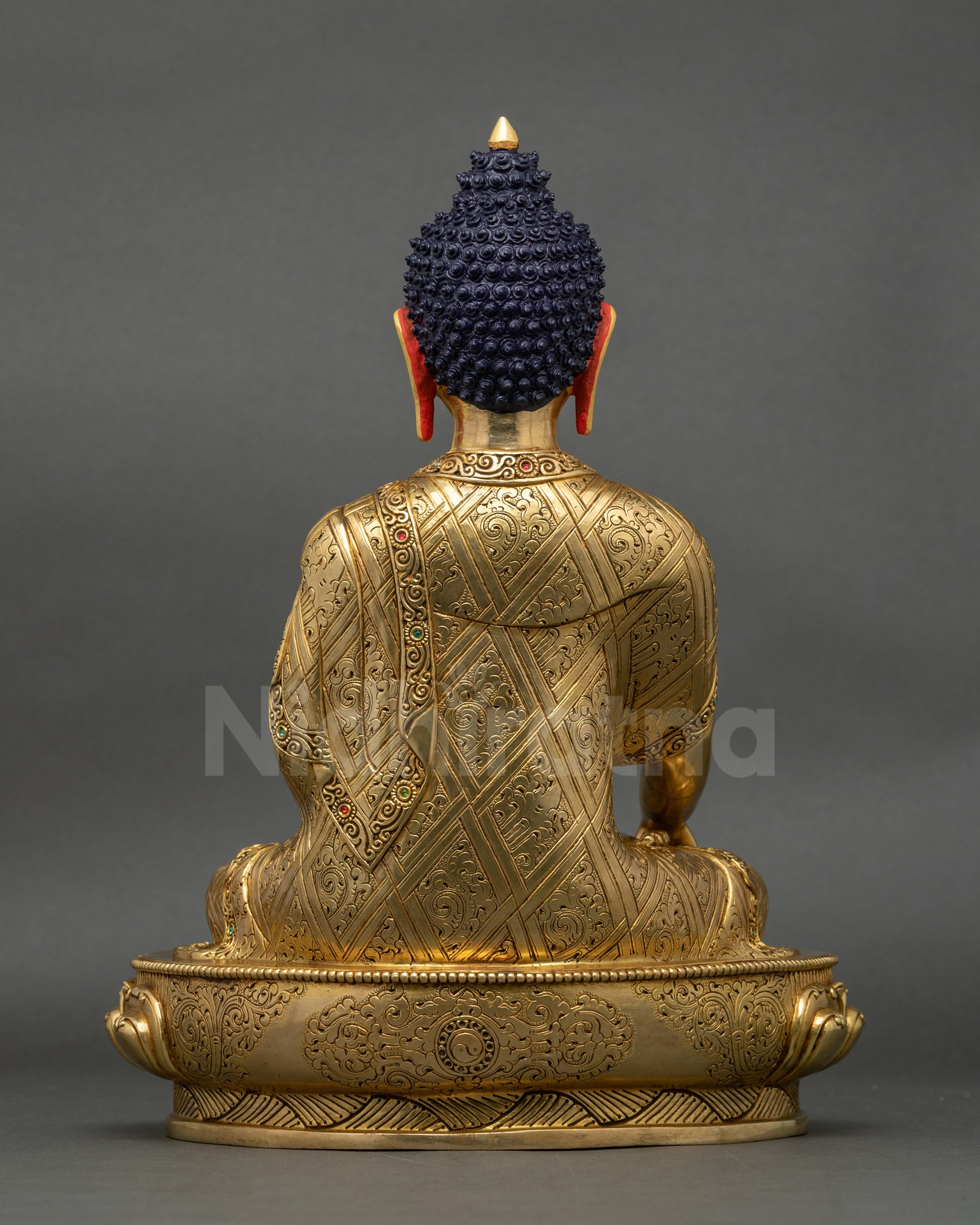 Back view of Shakyamuni Buddha statue, intricate robe patterns and lotus throne design