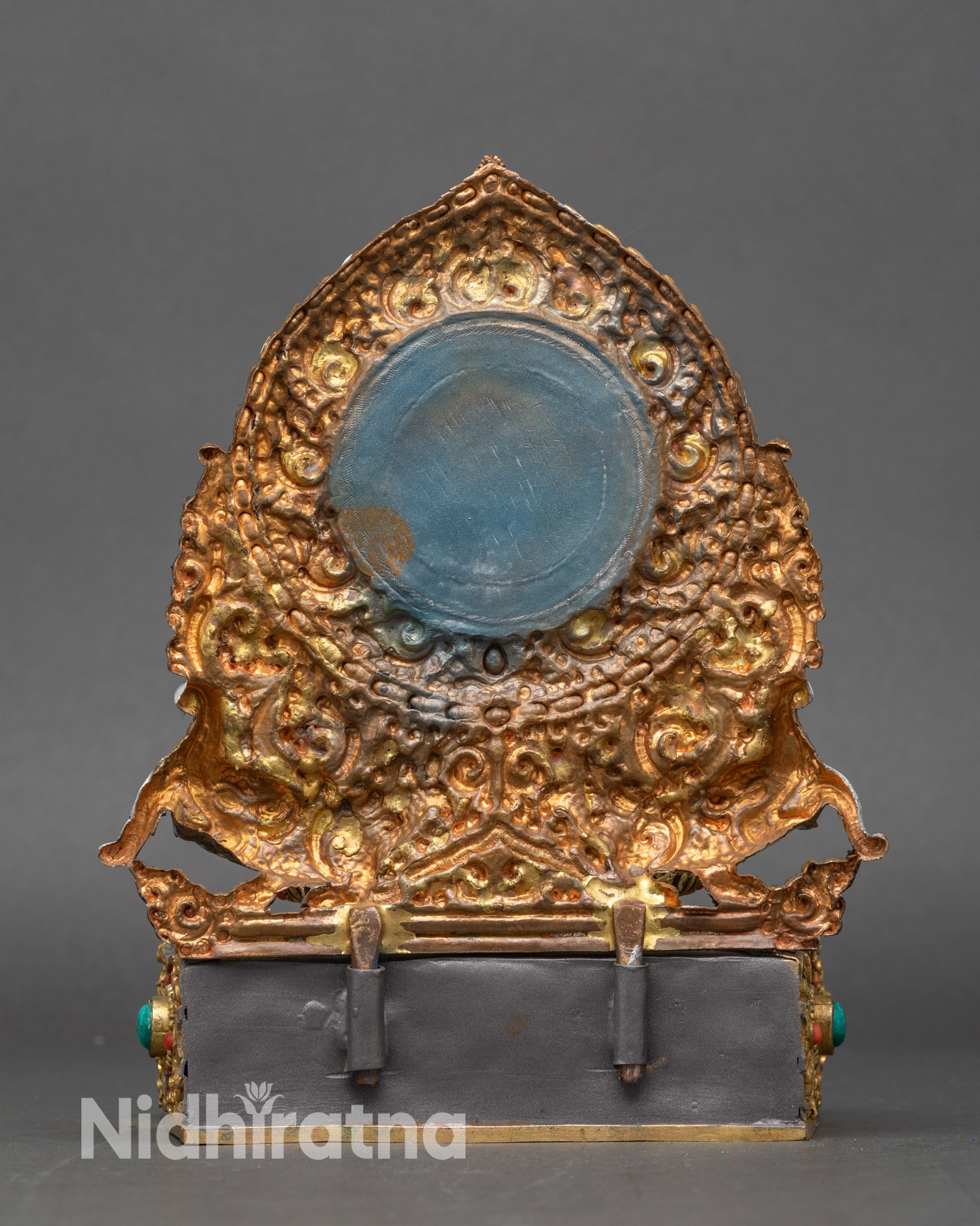 Back view of Shakyamuni Buddha statue with decorative halo and carvings