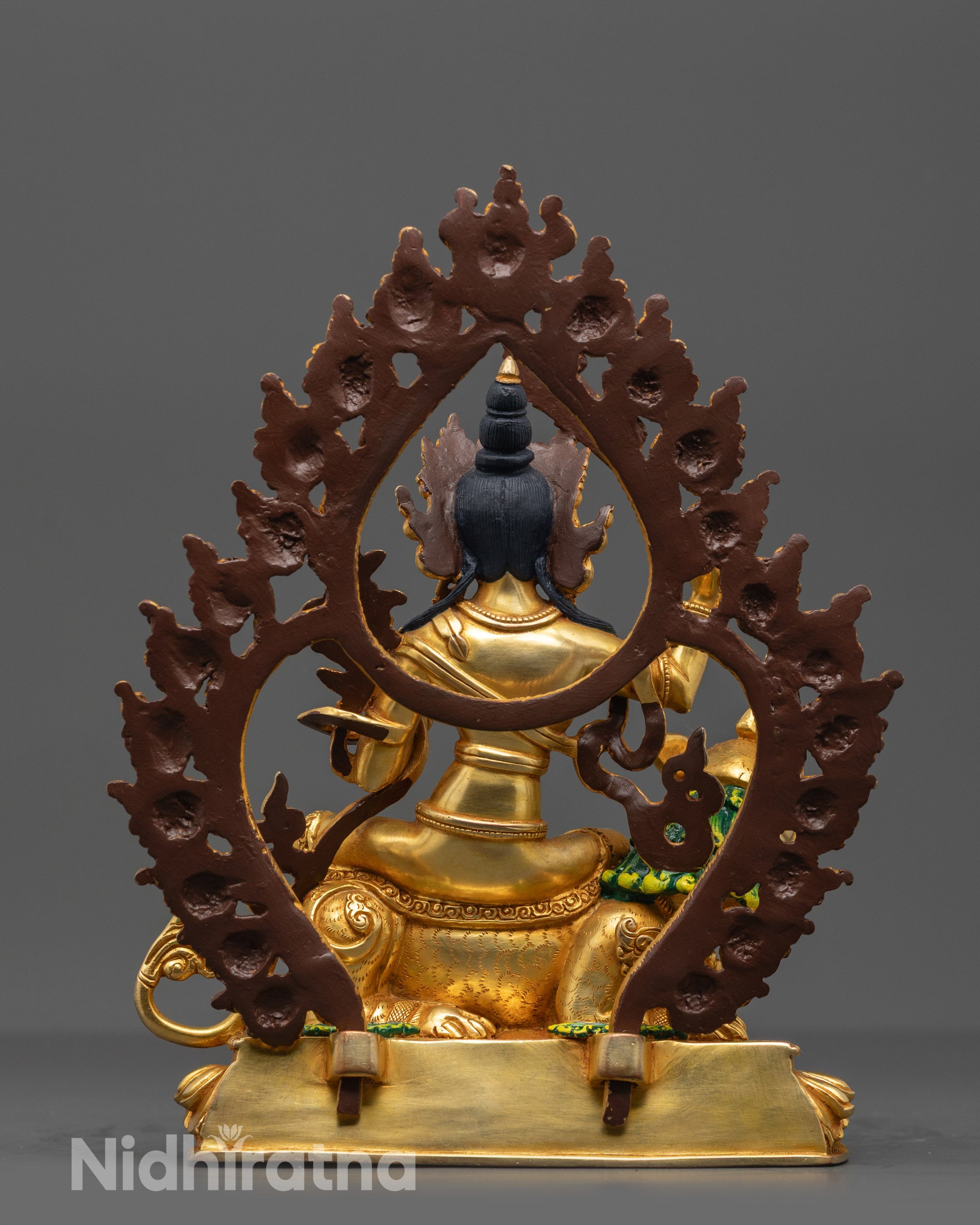 Back view of Simhada Manjushri showcasing carved details, sacred shells, and halo