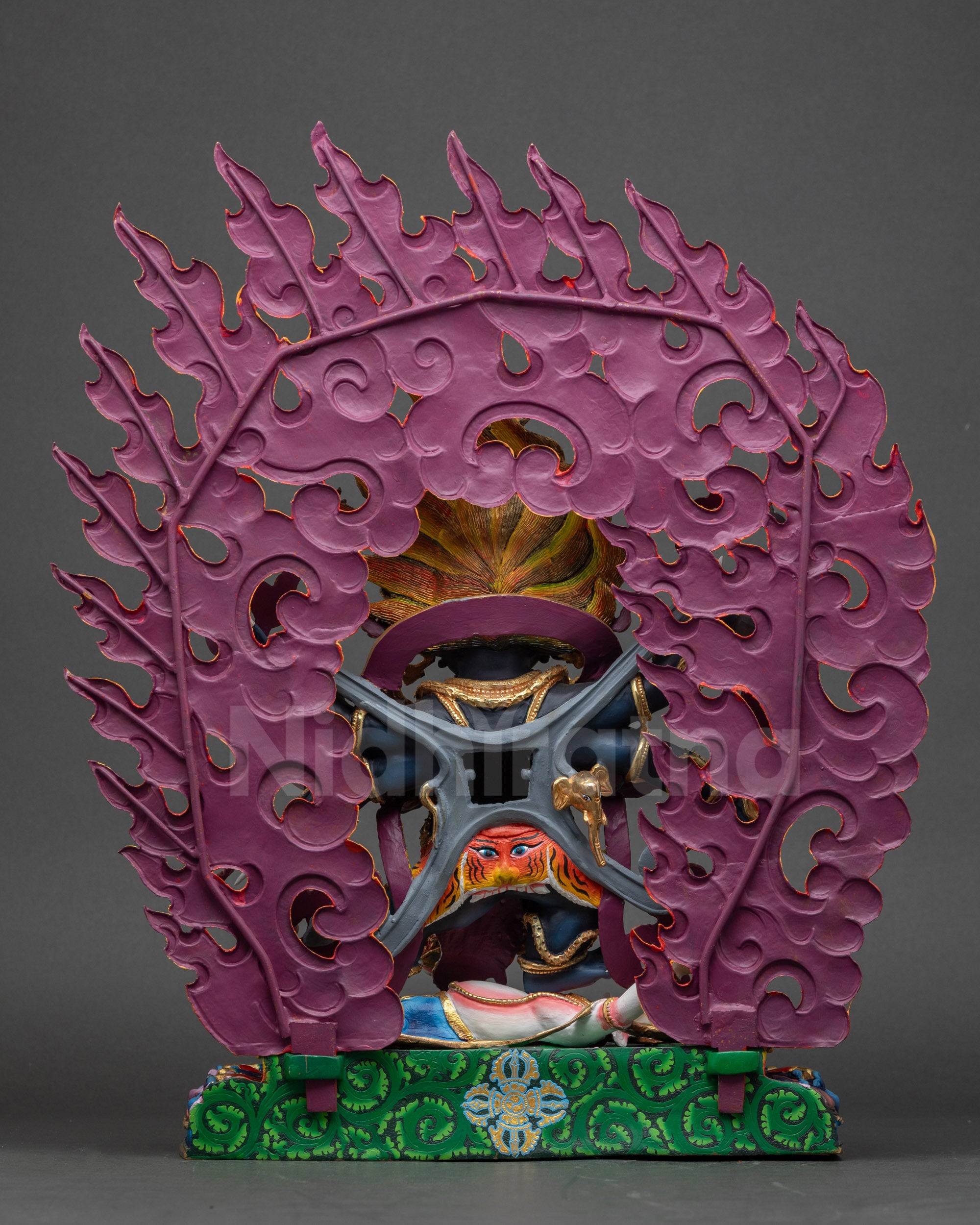 Back view of Six-Armed Mahakala Sculpture showing carved halo of wisdom flames and detailed copper textures