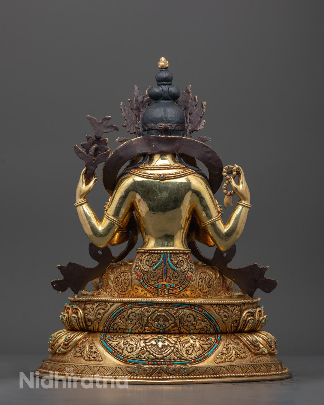 Back view of Tibetan Chenrezig statue highlighting lotus throne and fine artisan craftsmanship