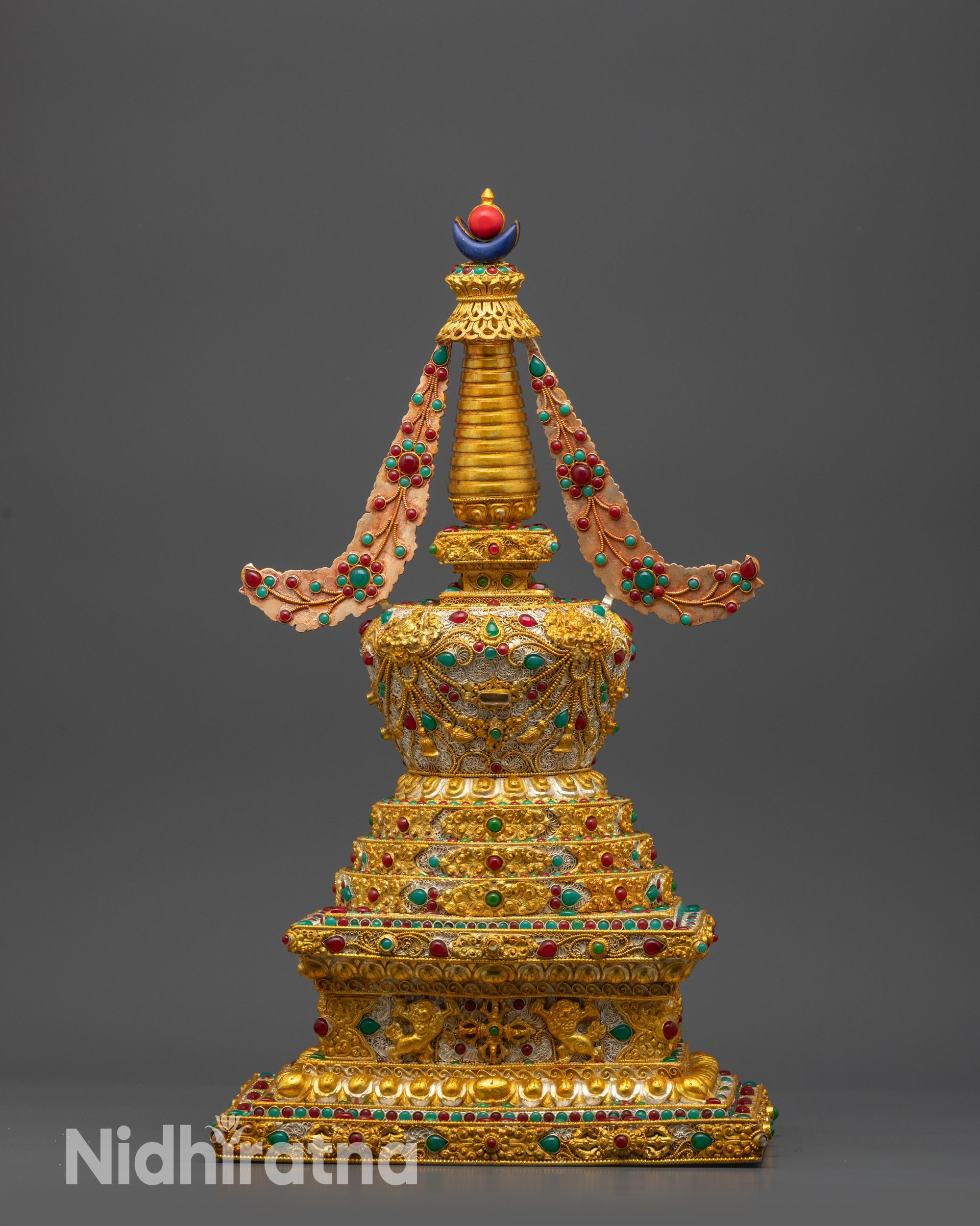 Back view of Tibetan Golden Stupa highlighting traditional carvings and spiritual motifs