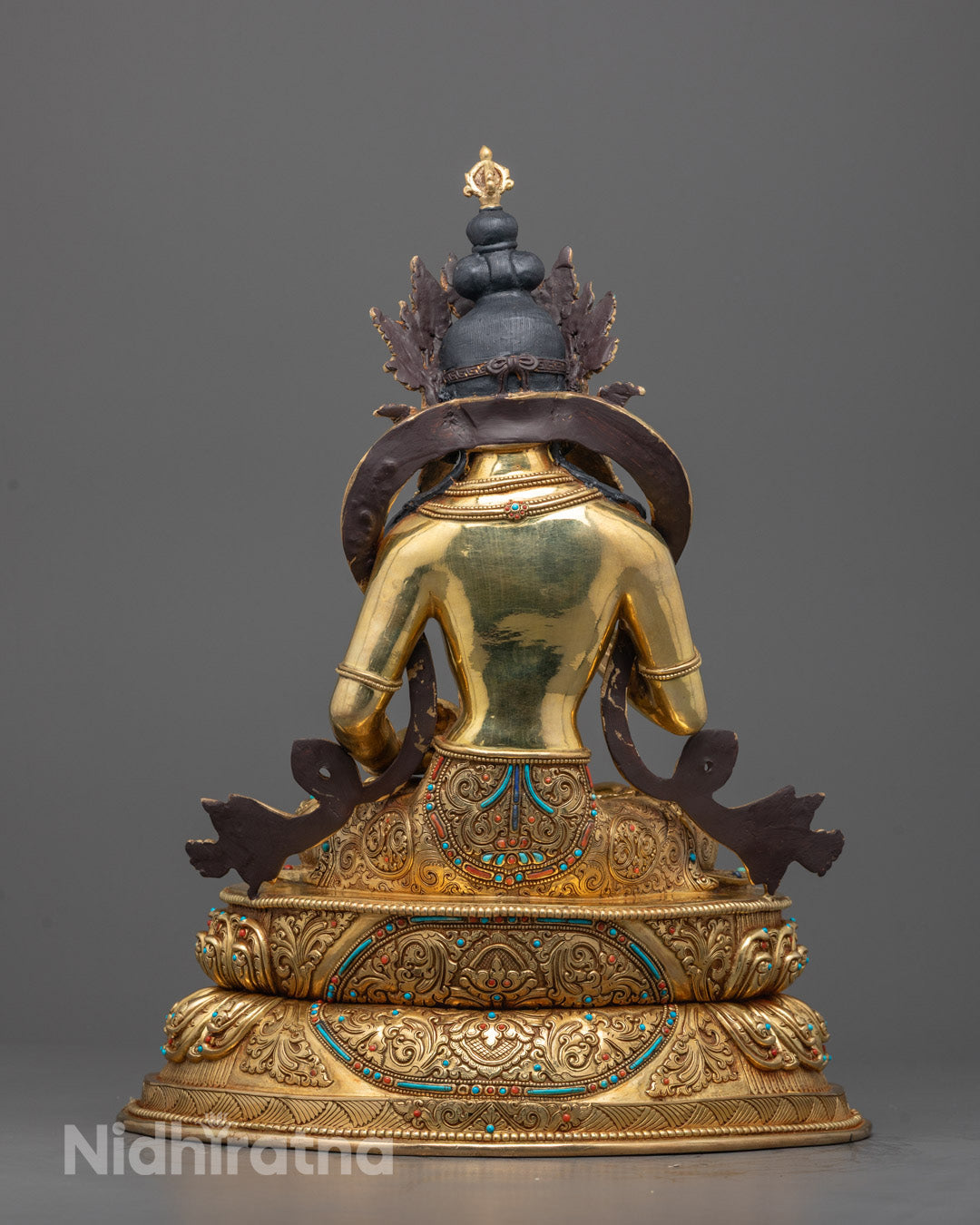 Back view of Tibetan Vajrasattva statue showing intricate floating robe and mantra chamber