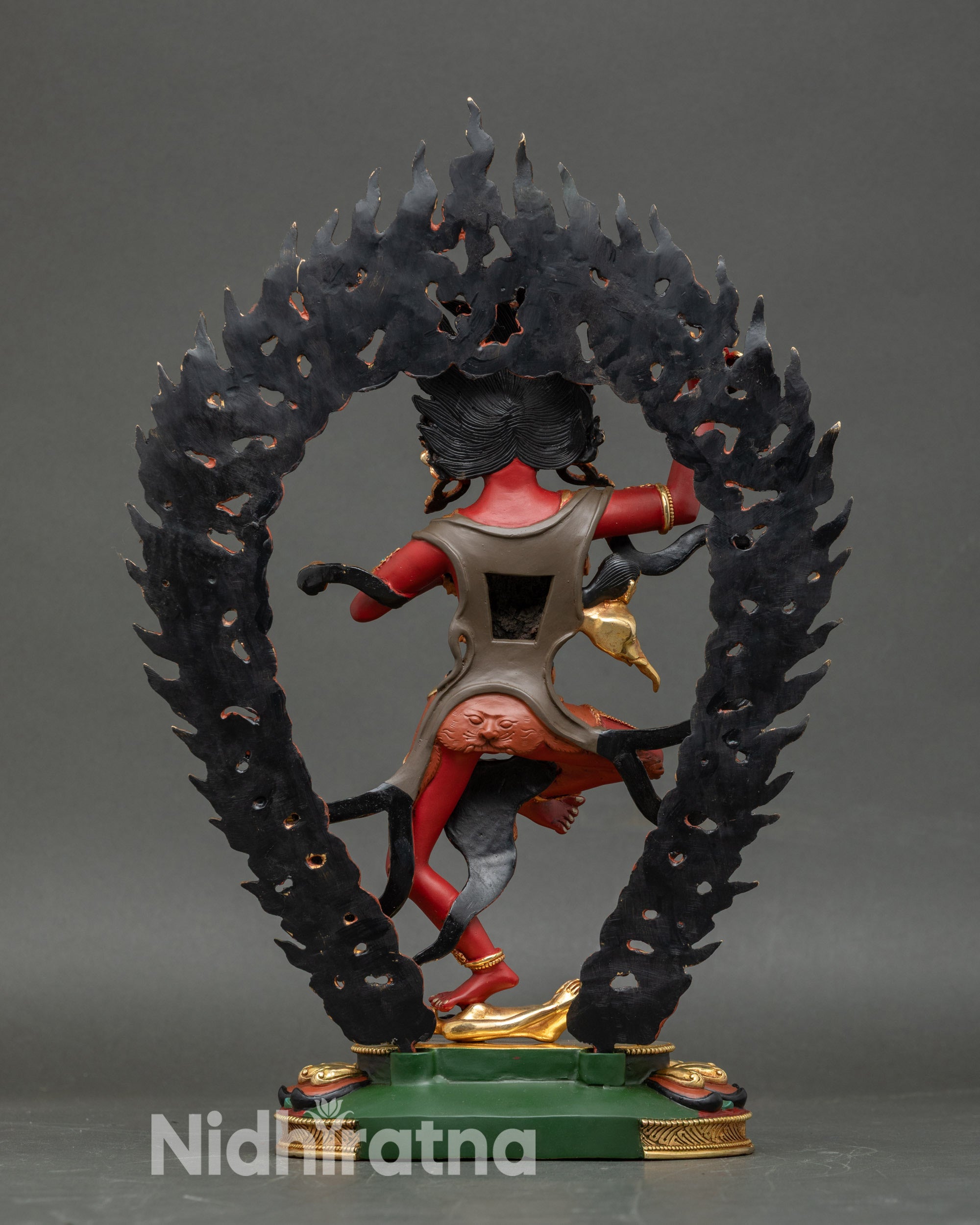 Back view of Troma Nagmo statue, intricate copper carving and radiant gold halo