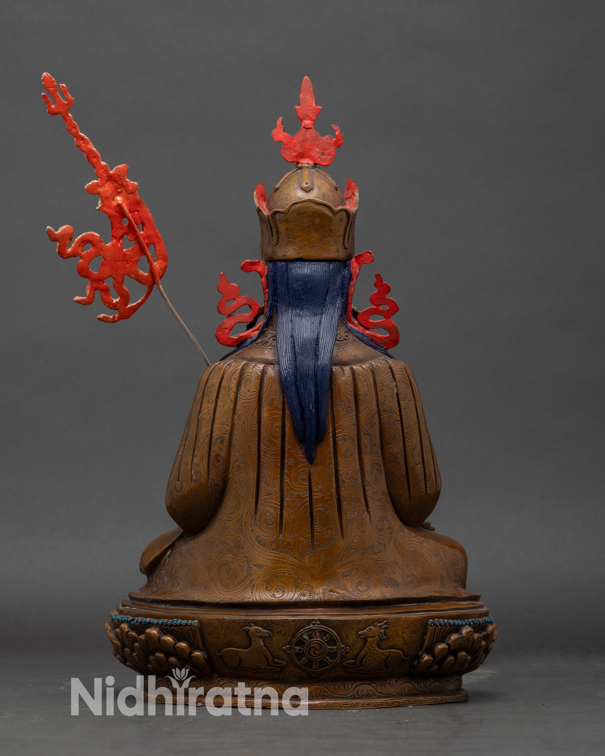 Back view of Tsokye Dorje statue revealing intricately carved robes and the lotus pedestal base.