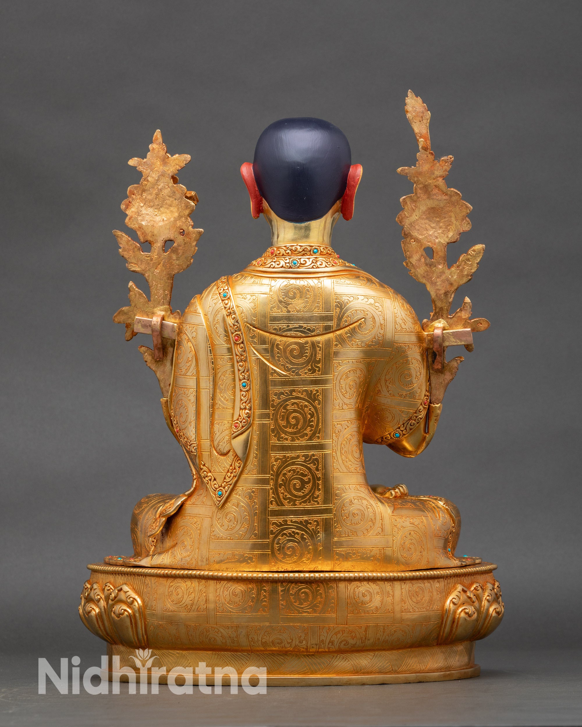 Back view of Tsongkhapa, showing engraved lotus base and detailed robe folds