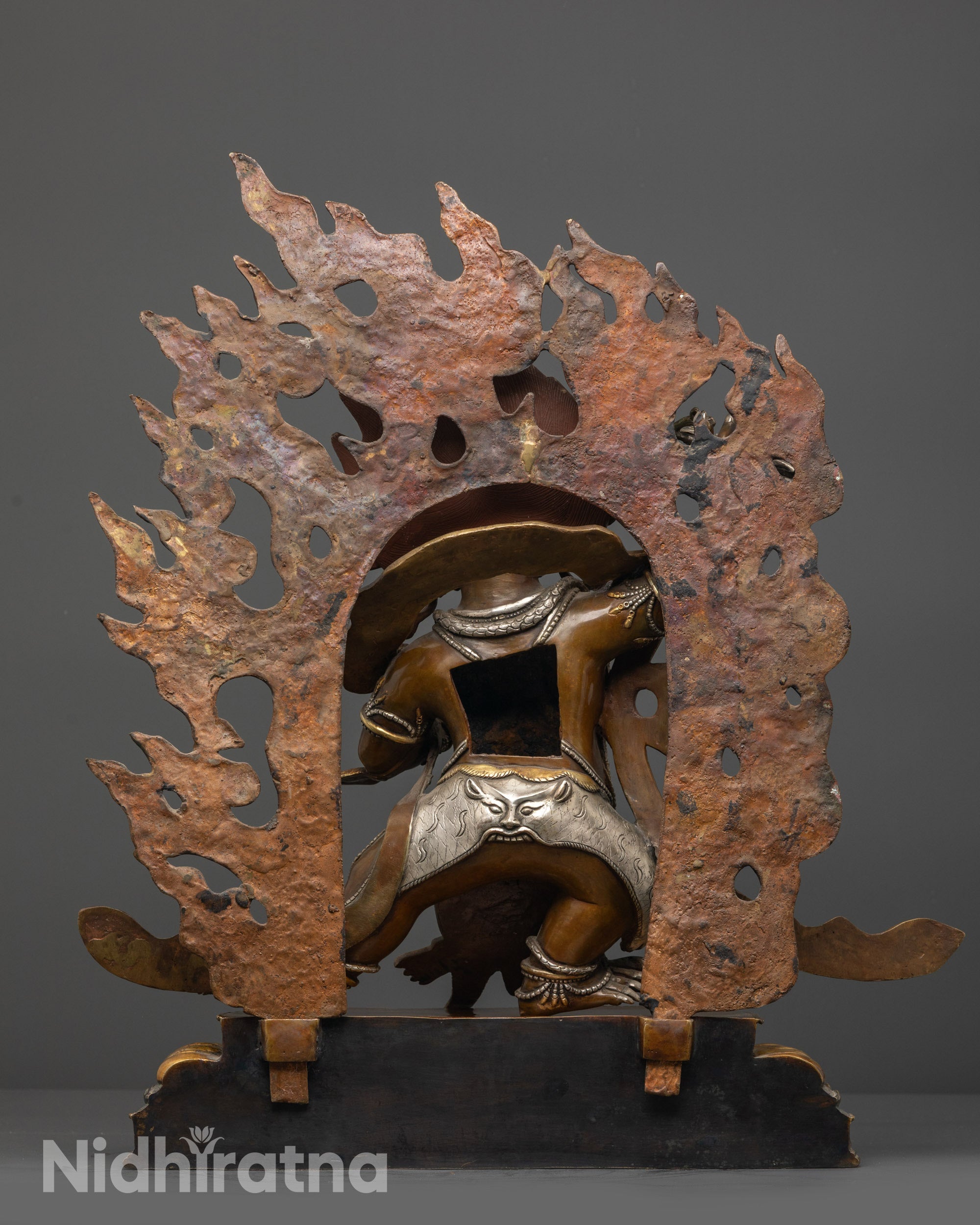 Back view of Vajrapani statue highlighting gold and silver-plated jewelry and detailing