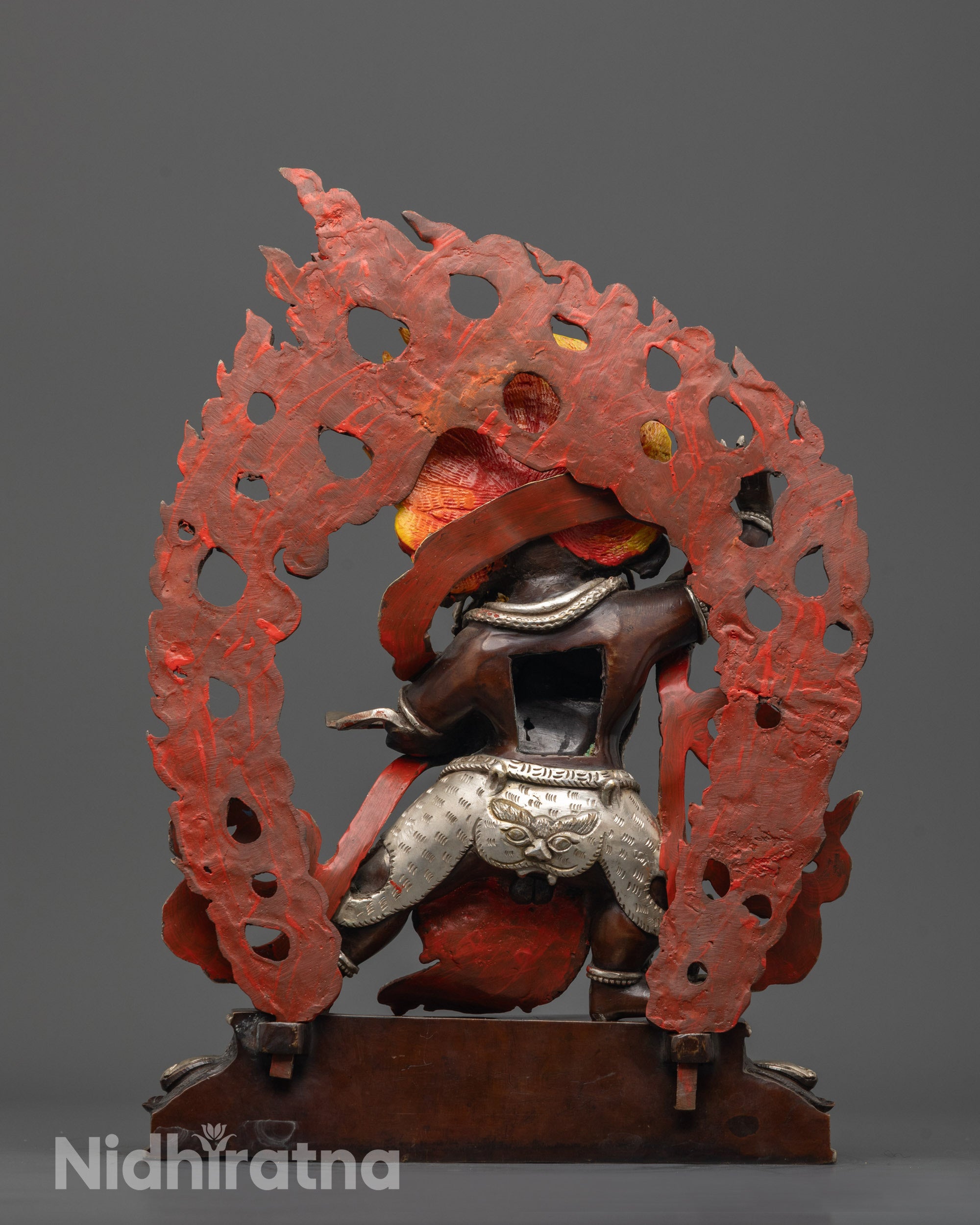 Back view of Vajrapani statue highlighting silver-plated fearful halo and tiger skin garment