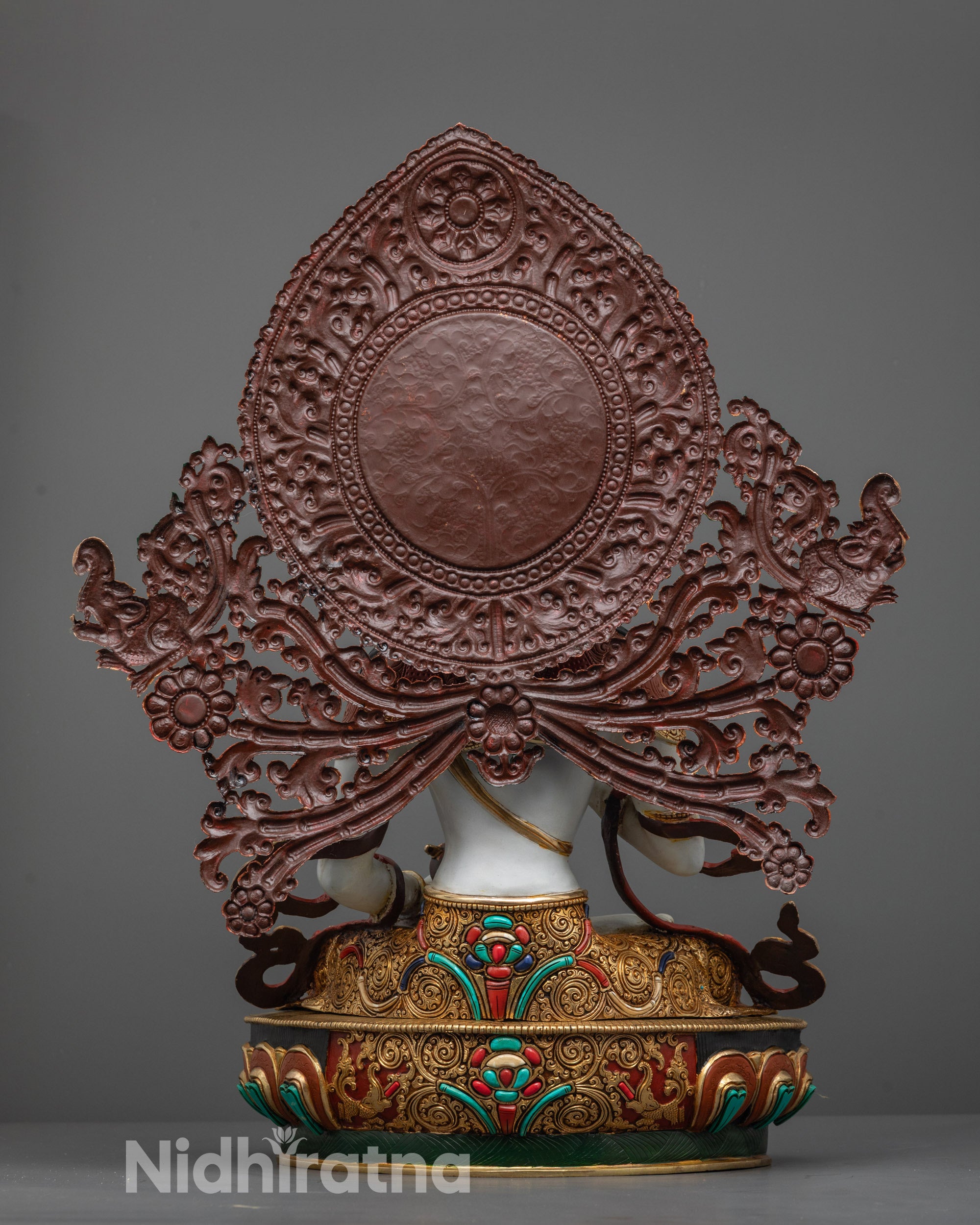 Back view of Vajrasattva Statue with halo adorned with flowers and semi-precious stones