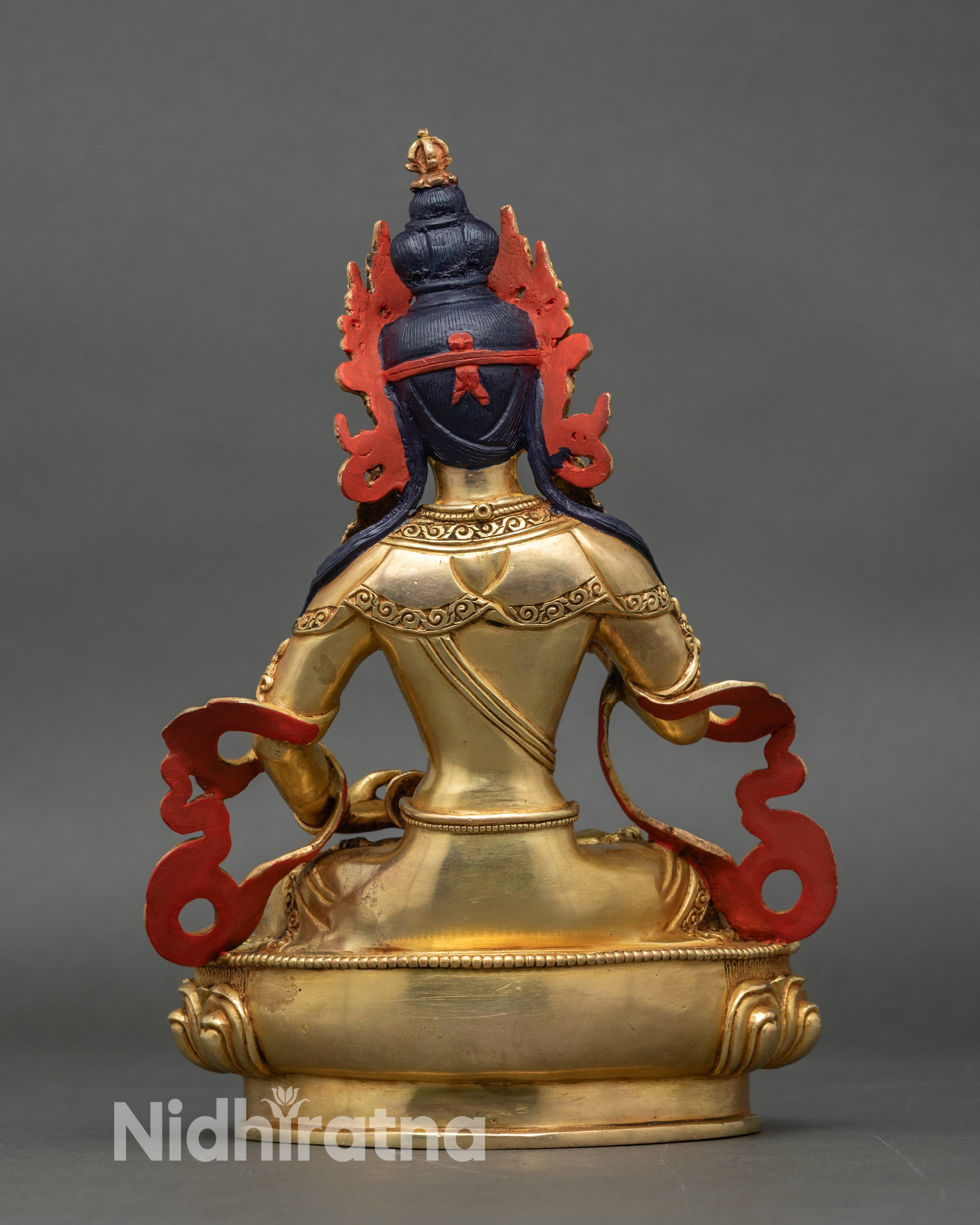 Back view of Vajrasattva idol showing detailed lotus seat and swirling robes