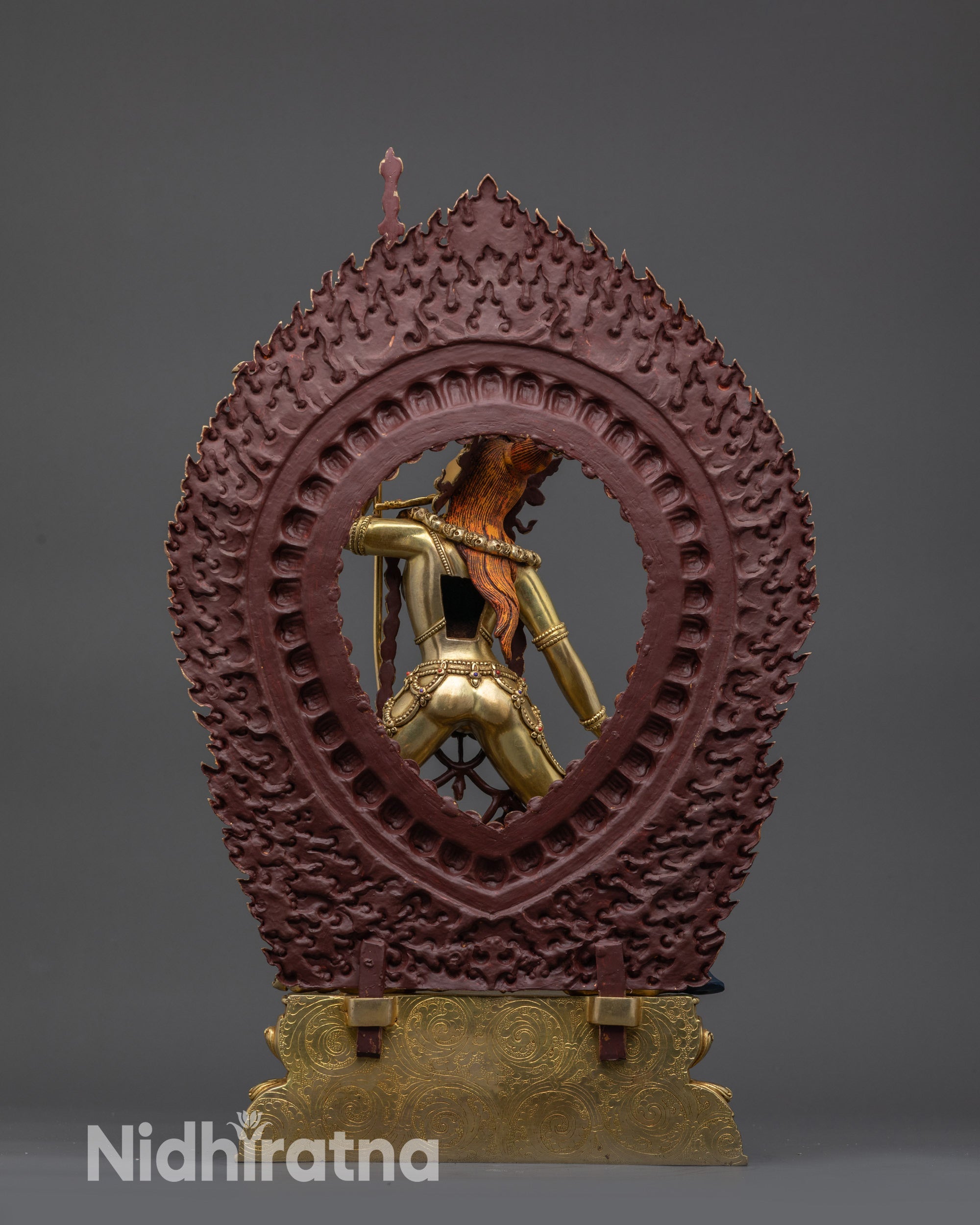 Back view of Vajrayogini statue with flaming halo and detailed carved robes Nepal