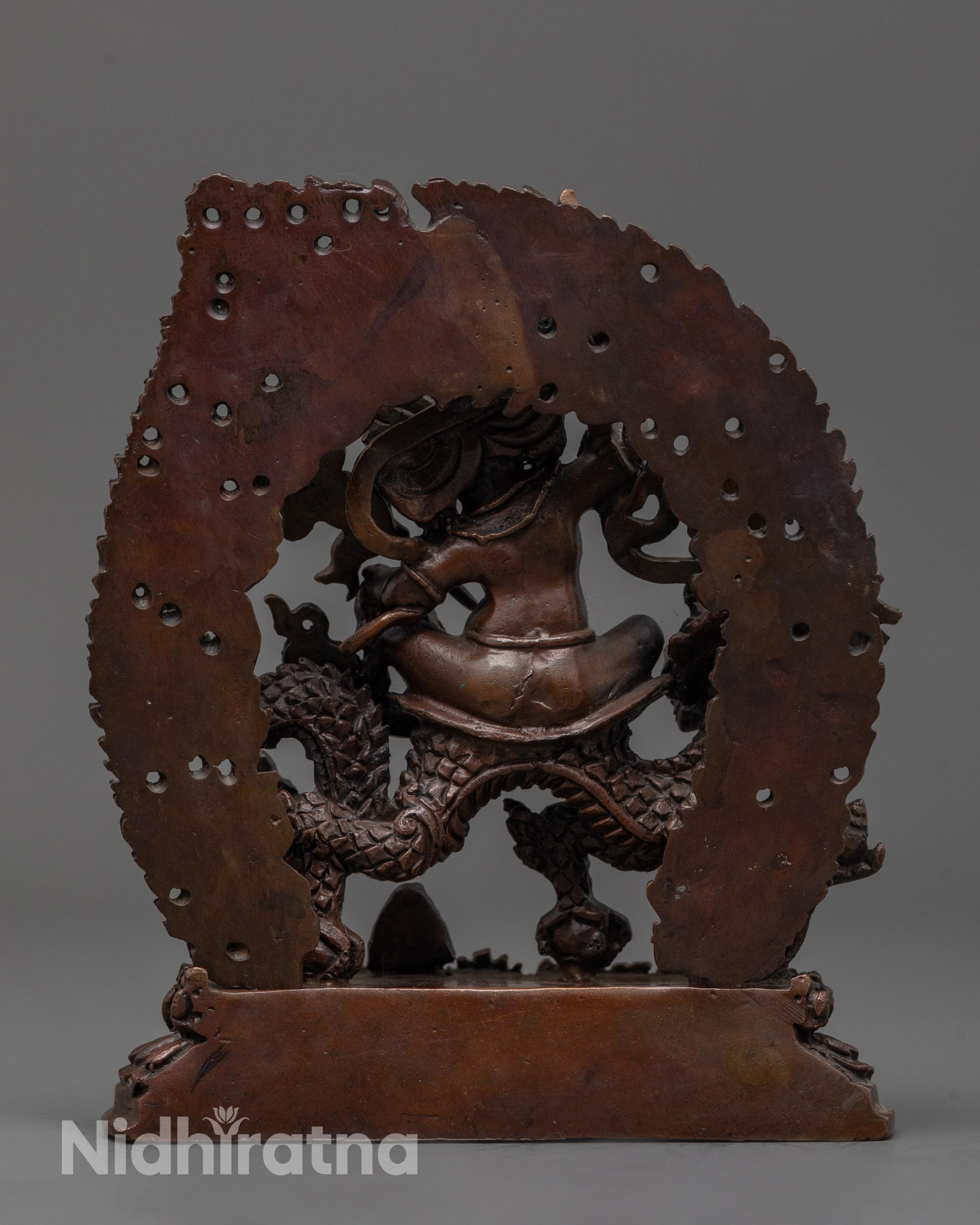 Back view of White Dzambhala Statue highlighting detailed halo and flowing garments