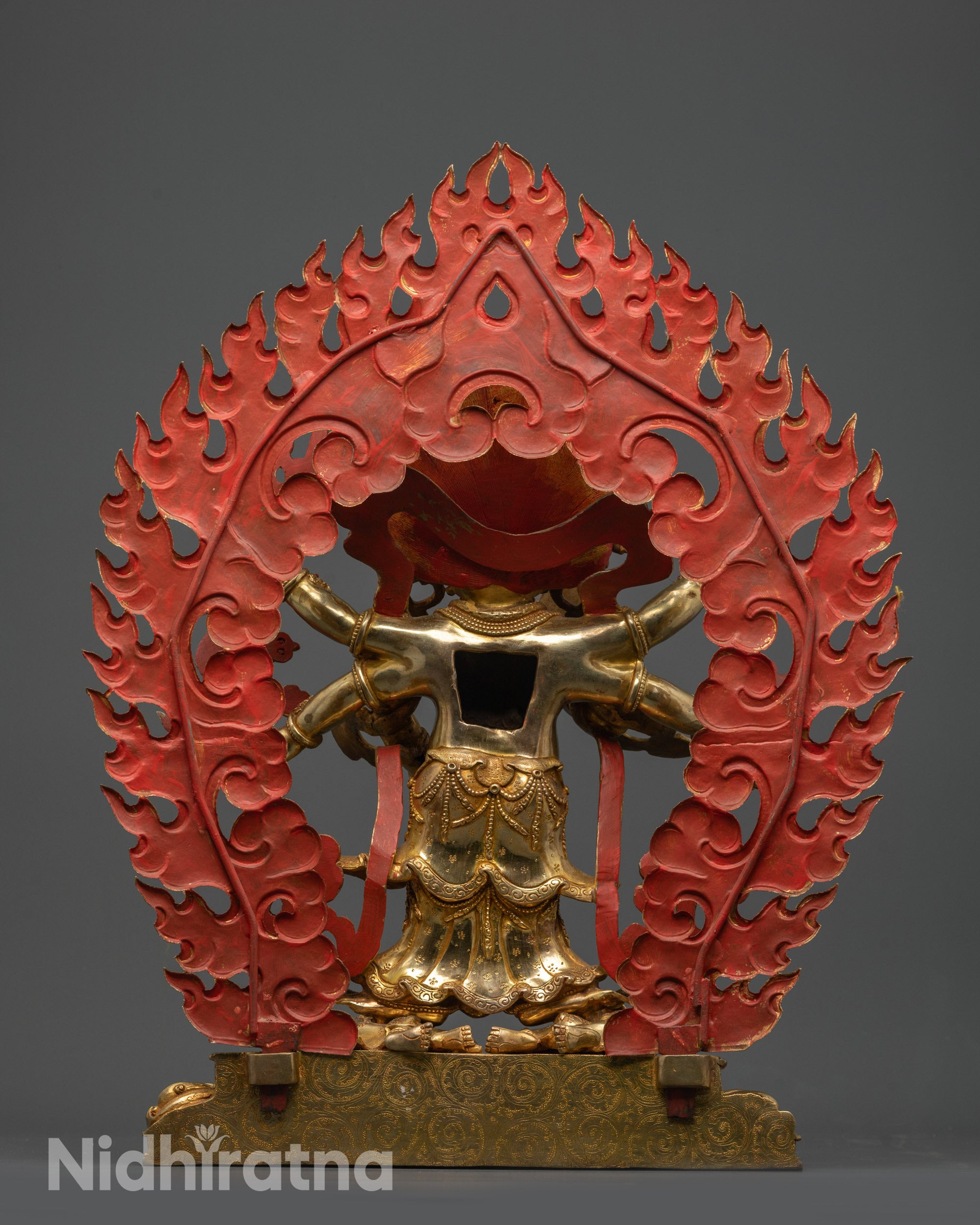Back view of White Mahakala Statue highlighting detailed halo, flowing robe, and carved lower garments