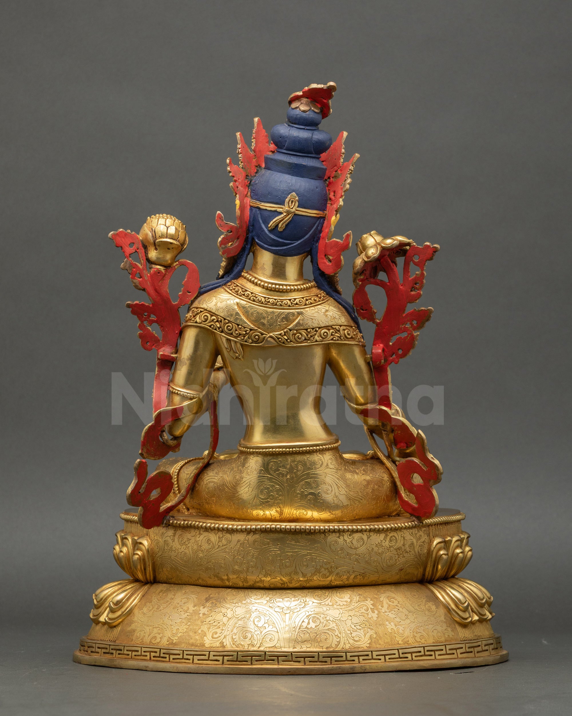 Back view of White Tara Statue highlighting carved jewelry and lotus throne