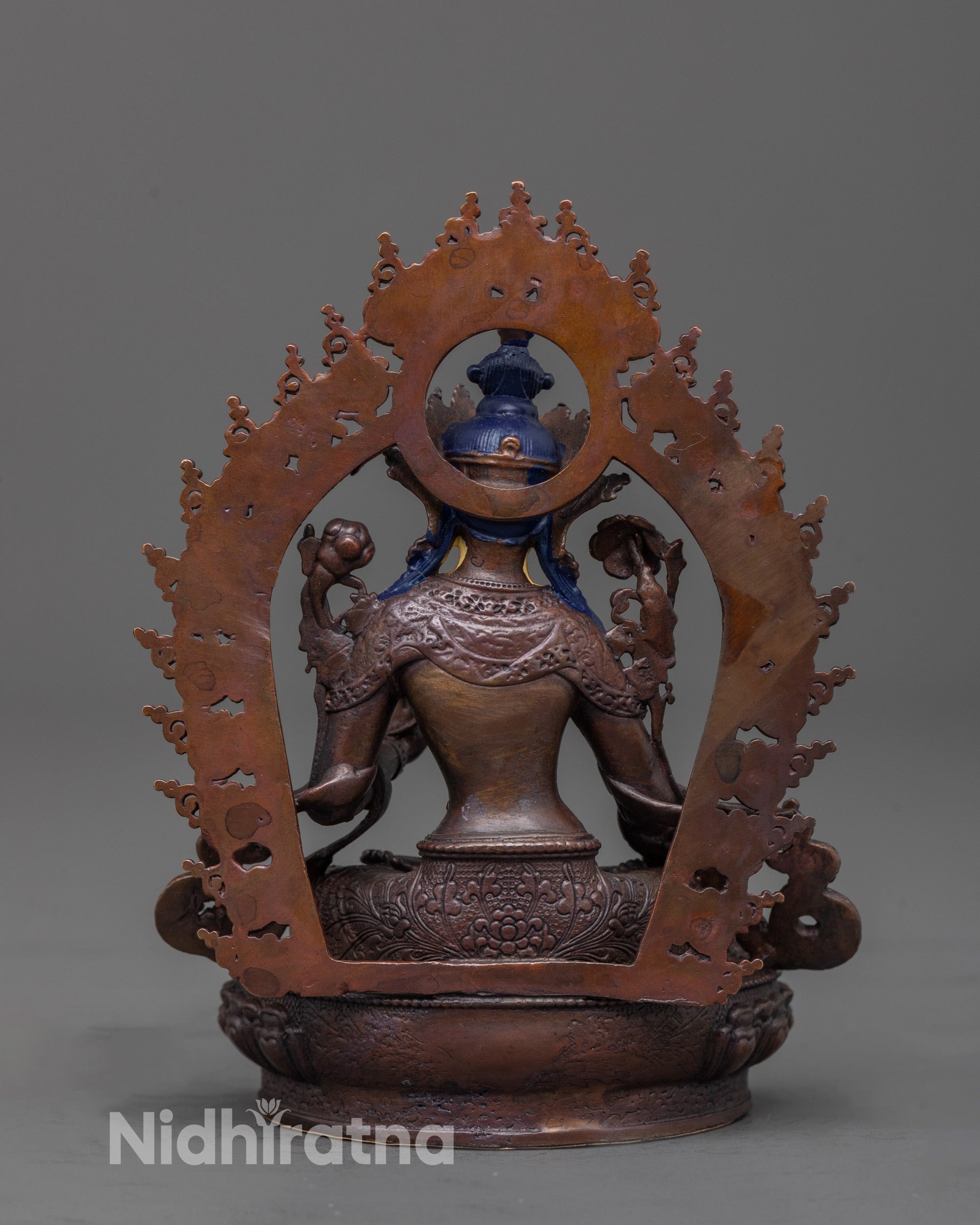 Back view of White Tara Statue highlighting oxidized copper body and lotus seat design