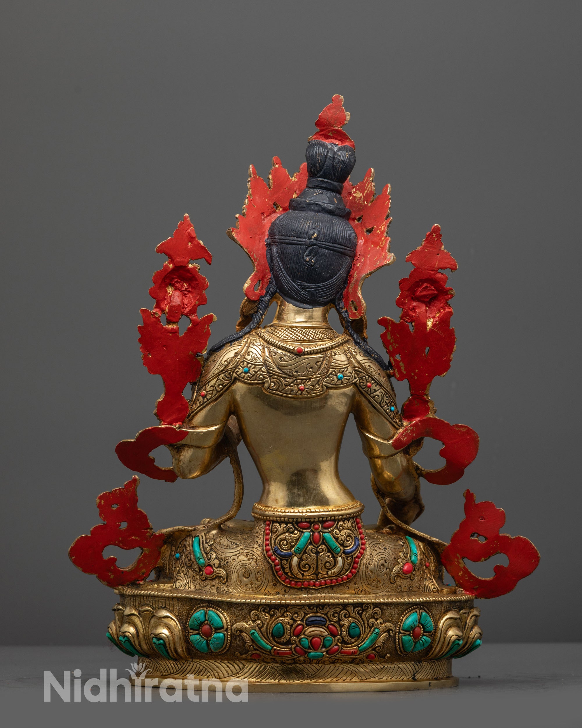 Back view of White Tara copper statue featuring lotus seat and carved jewelry patterns