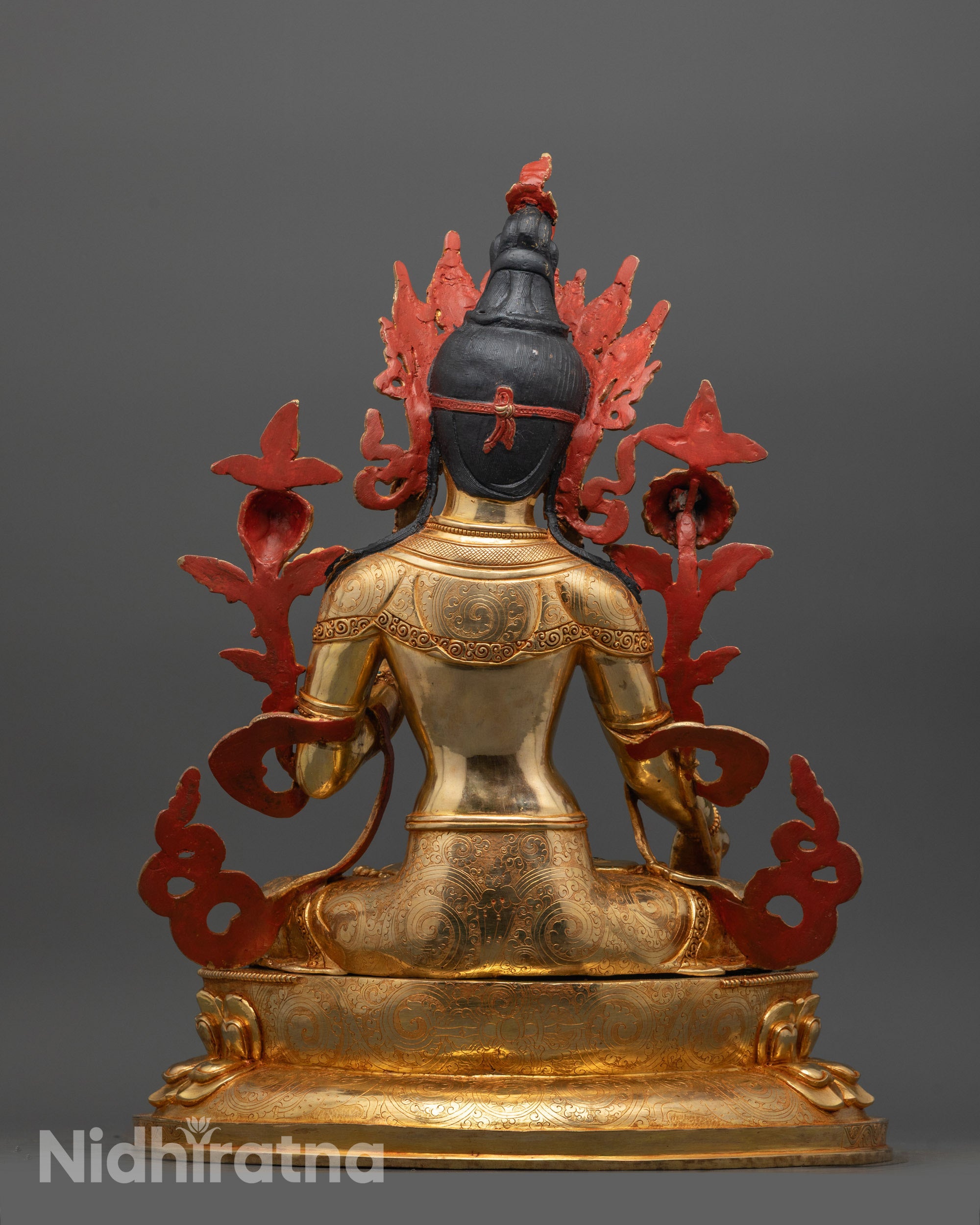 Back view of White Tara statue highlighting gold fire-gilded body and detailed jewelry patterns
