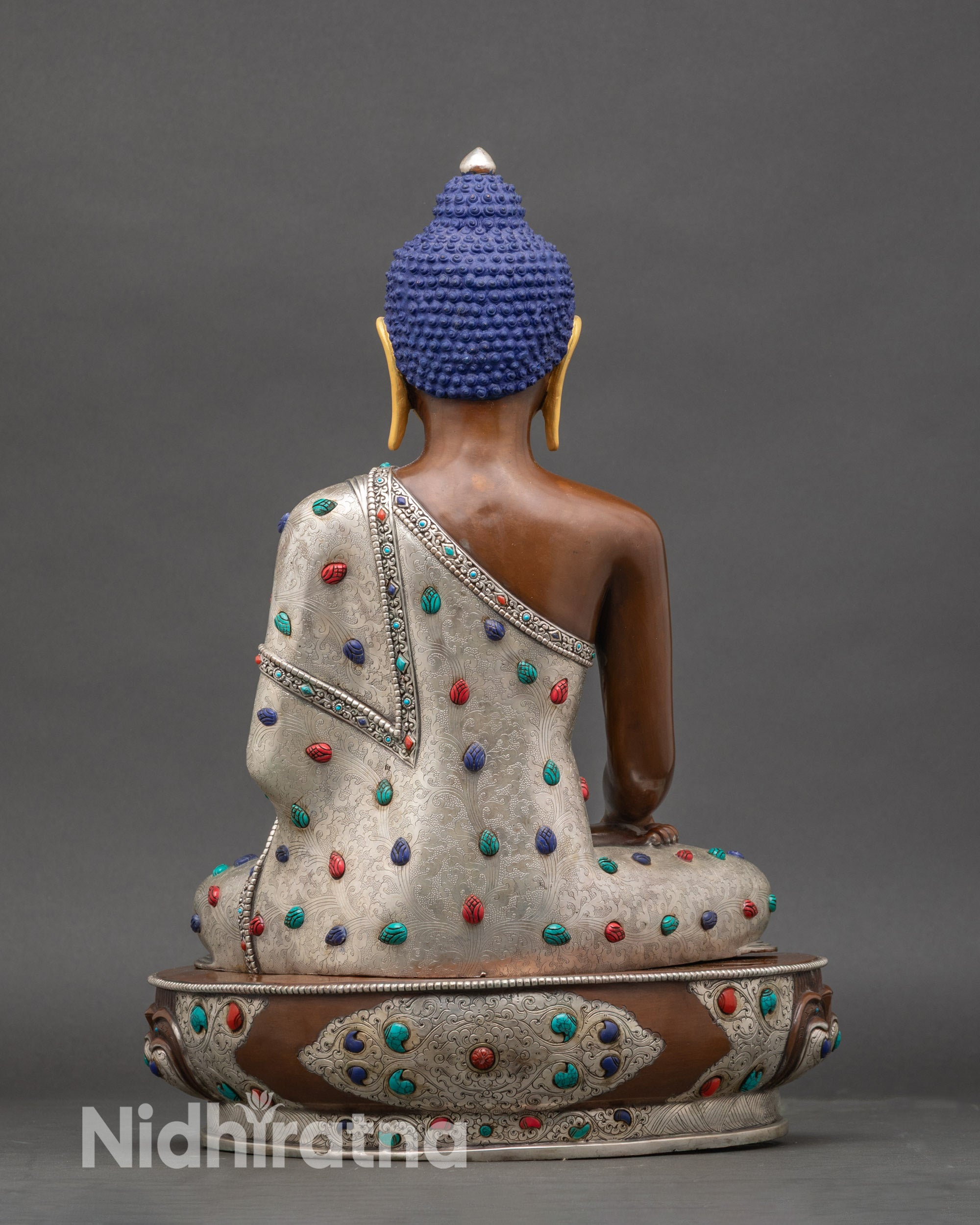 Back view of authentic Newari-crafted Buddha meditation figure with lotus seat