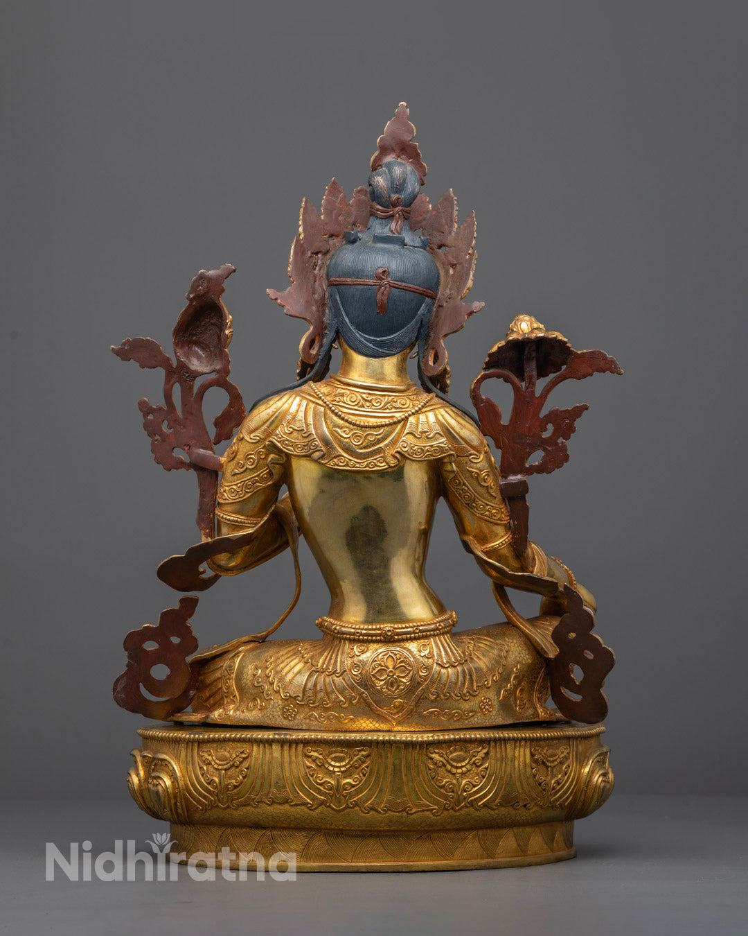 Back view of detailed Mother Tara Statue with intricate robe patterns and lotus base