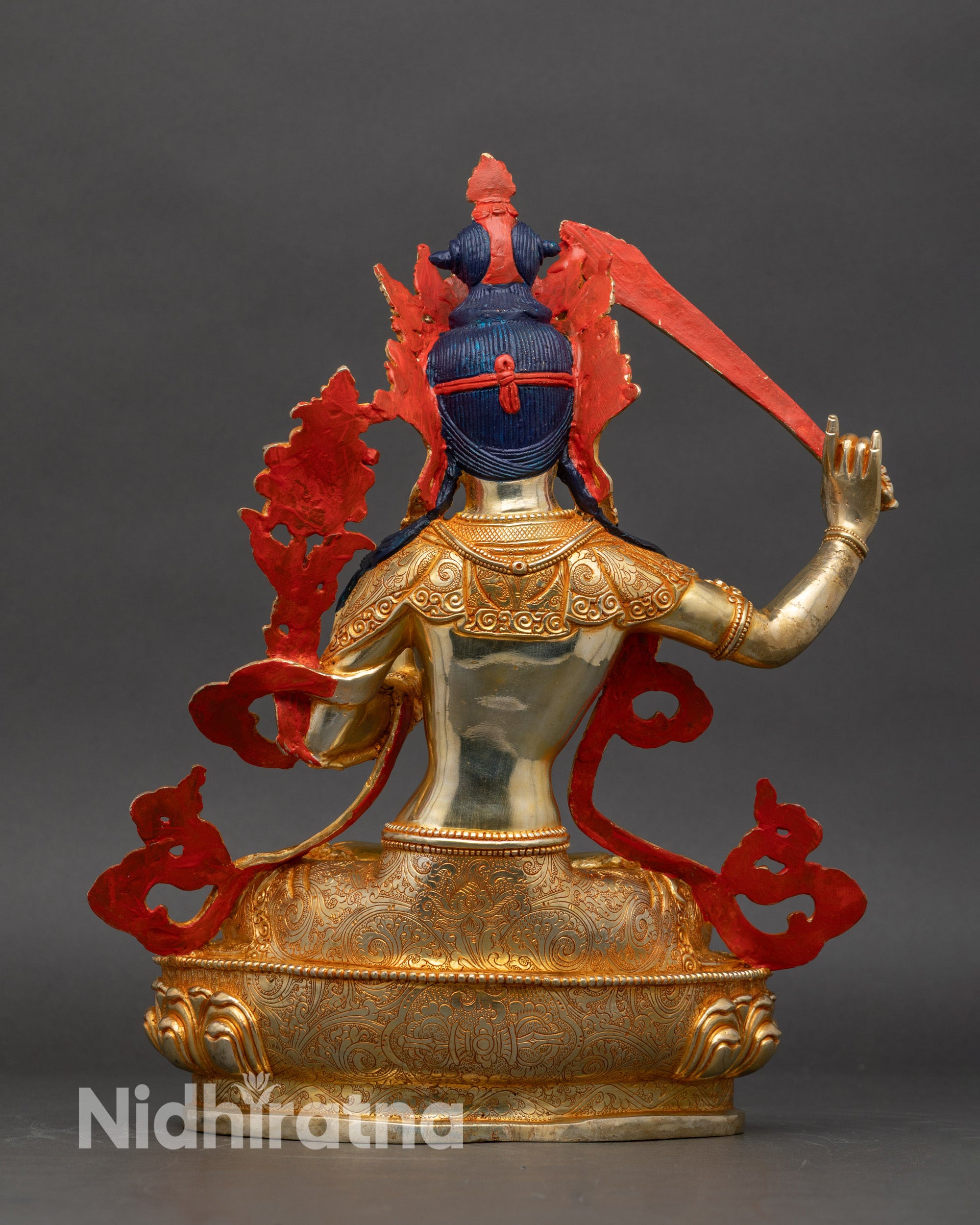 Back view of gold-gilded Manjushri sculpture, traditional Nepalese lost-wax casting