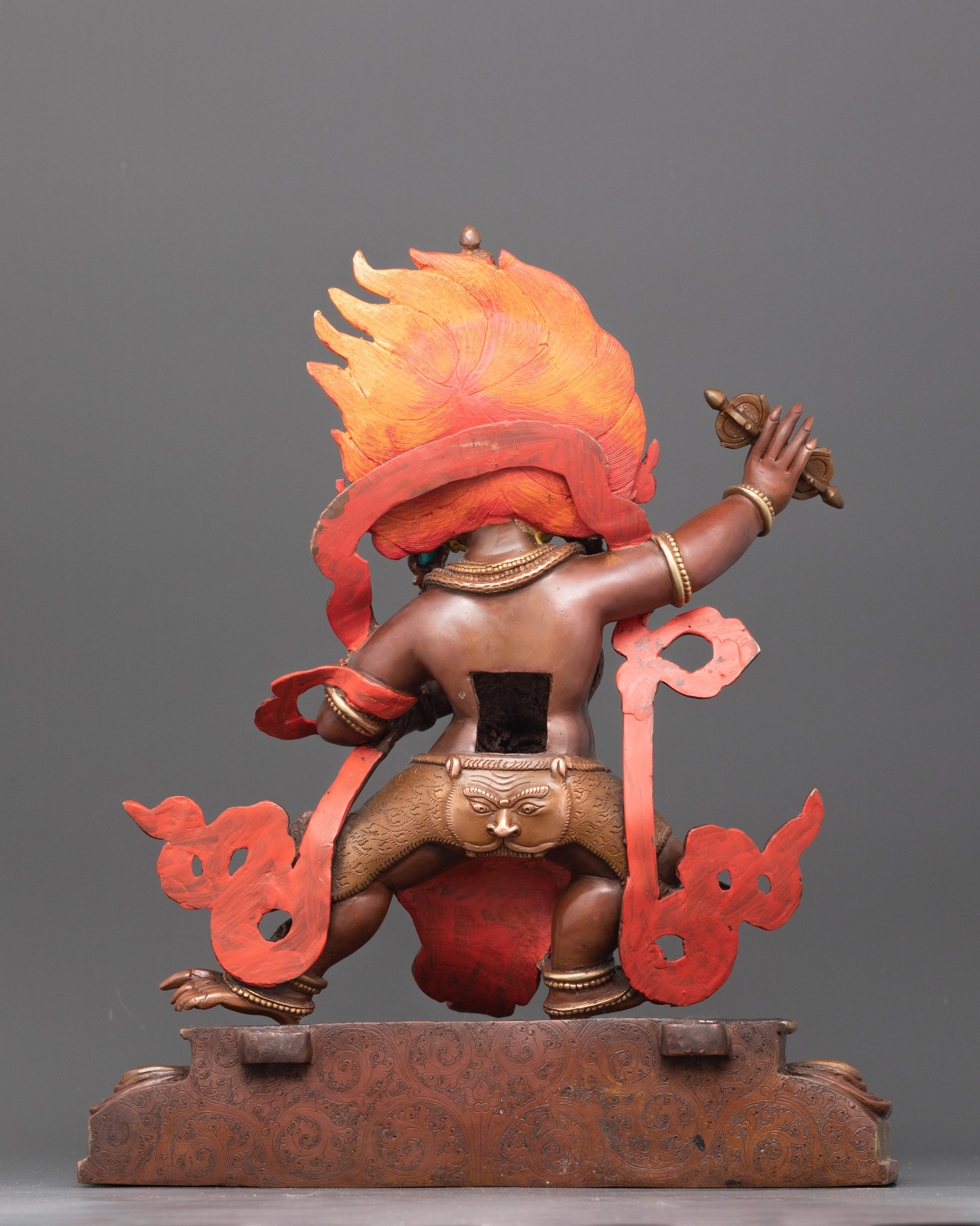 Back view of gold-gilded Vajrapani with lotus base and intricate flame details