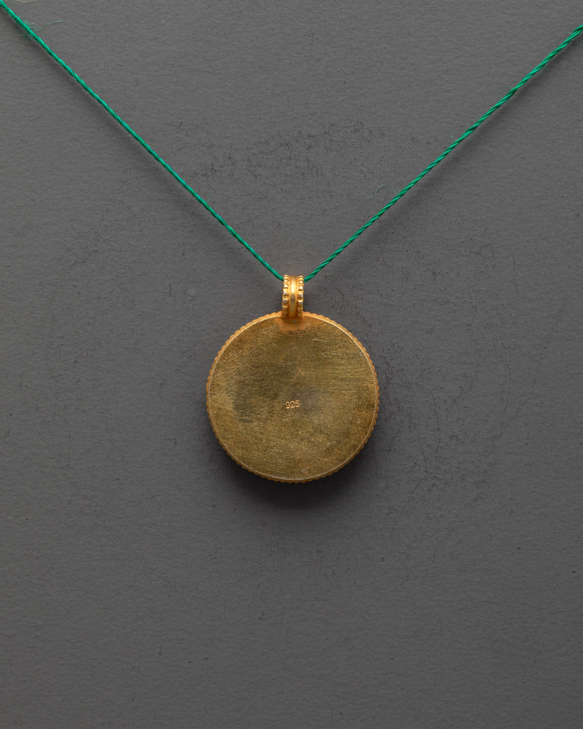 Back view of gold-plated copper Shell Locket highlighting artisan craftsmanship and finish