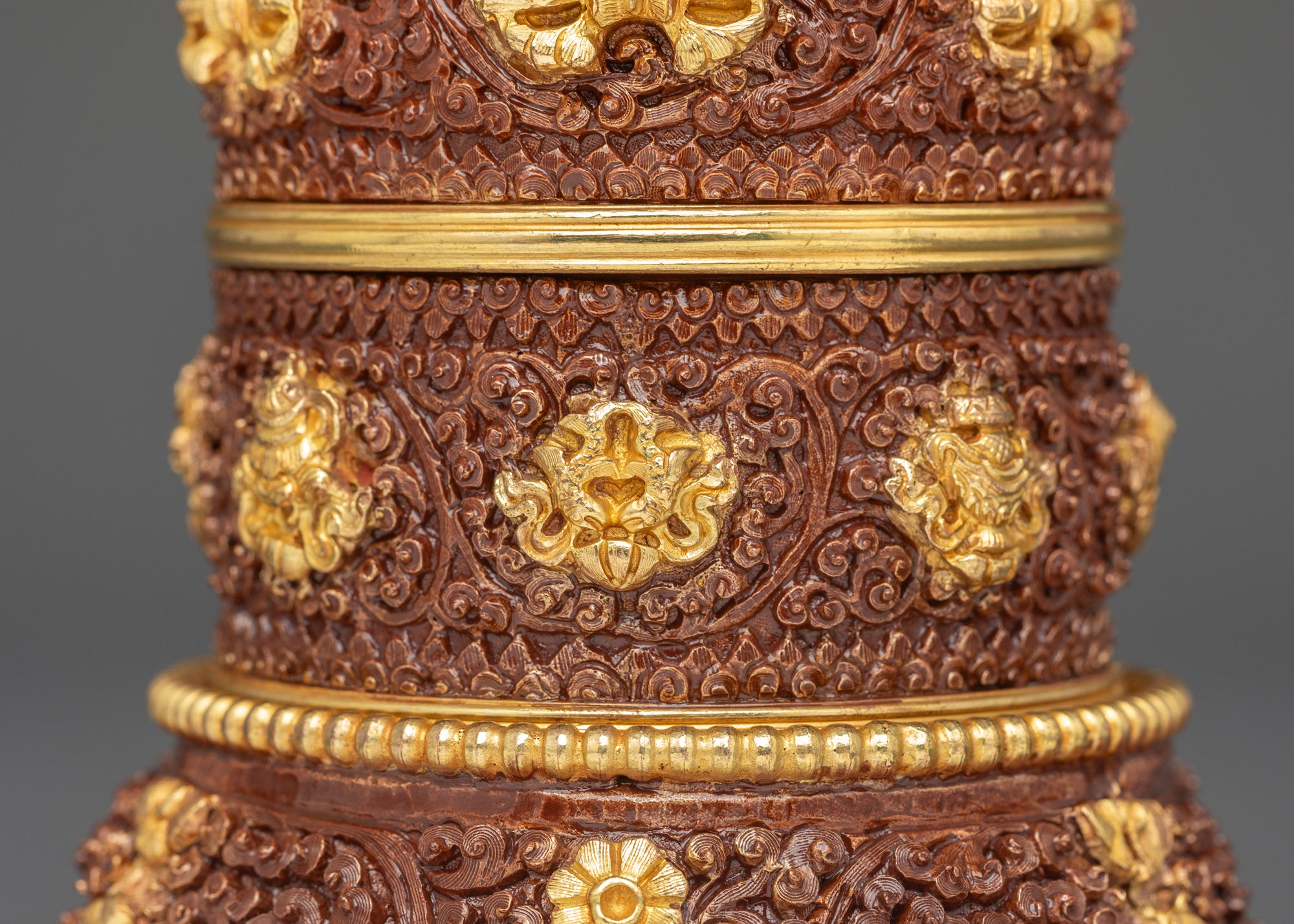 Back view of gold-plated copper rice pot with intricate spiritual details