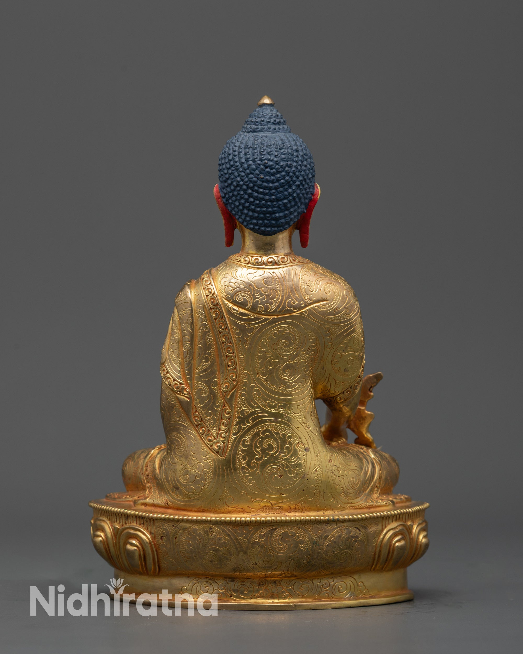 Back view of gold fire-gilded Medicine Buddha statue highlighting detailed craftsmanship