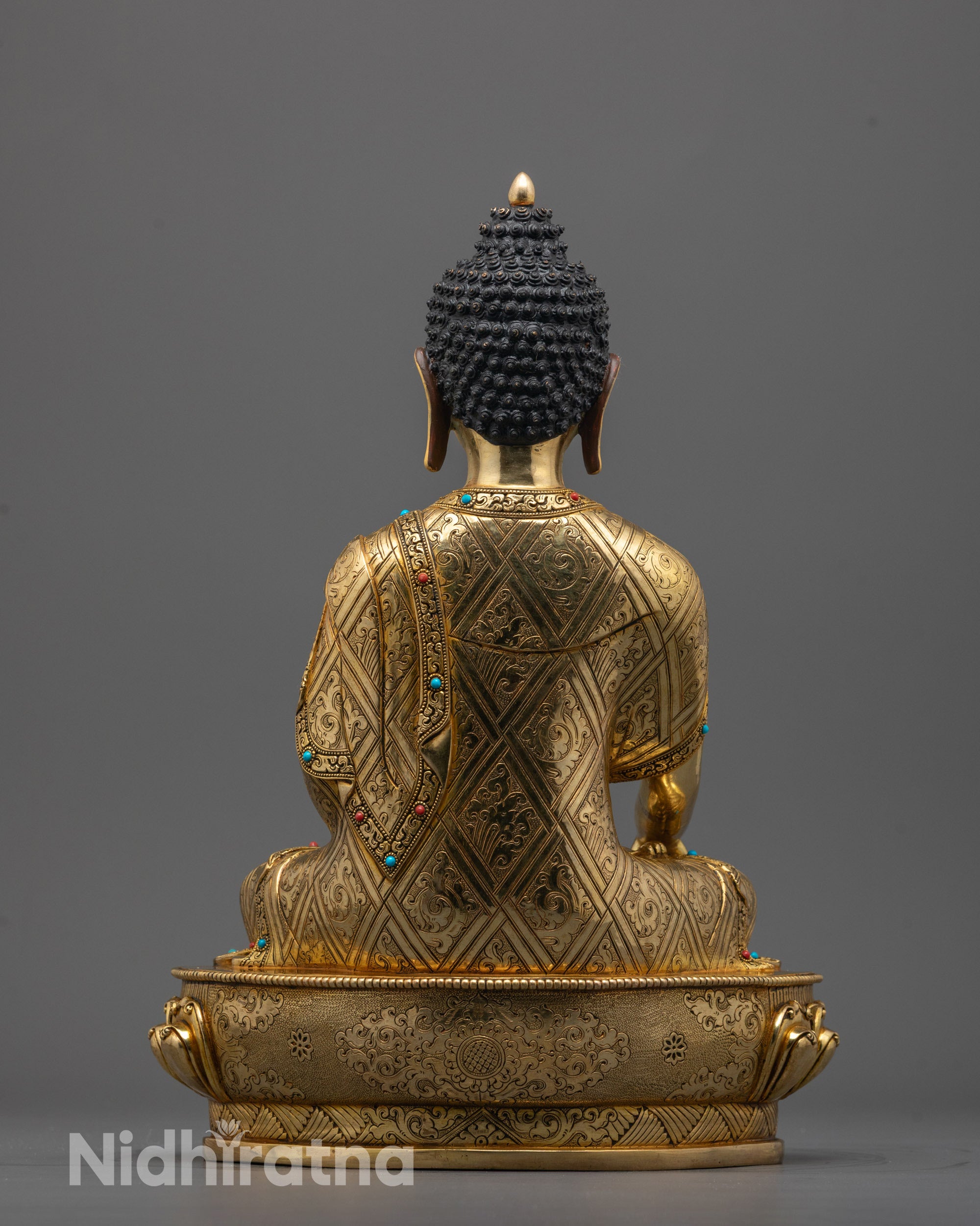 Back view of handcrafted Buddha Shakyamuni statue adorned with semi-precious stones from Nepal
