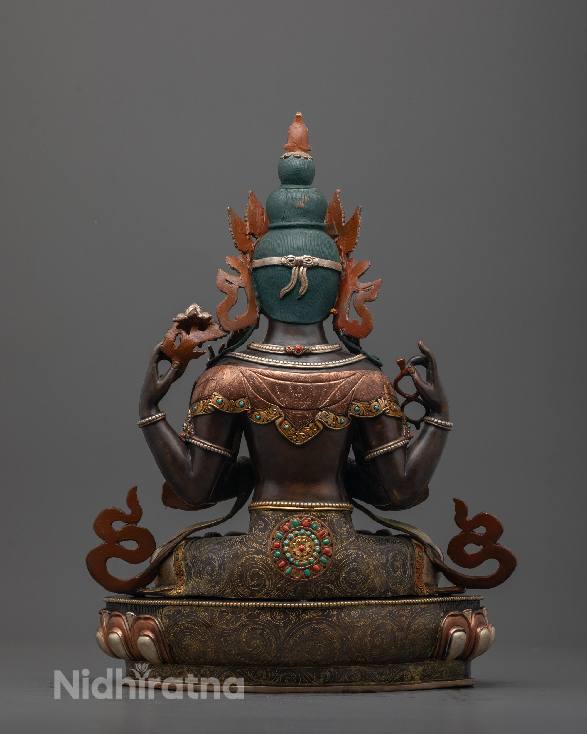Back view of handcrafted Chenrezig Statue with detailed robe, halo, and intricate carvings