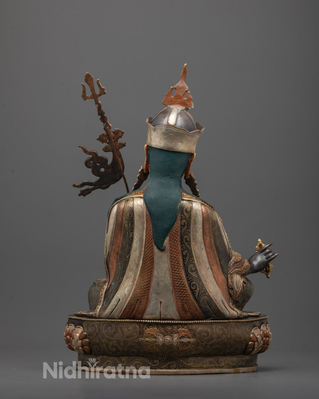 Back view of handcrafted Guru Rinpoche Sculpture showing detailed robe patterns and trident design
