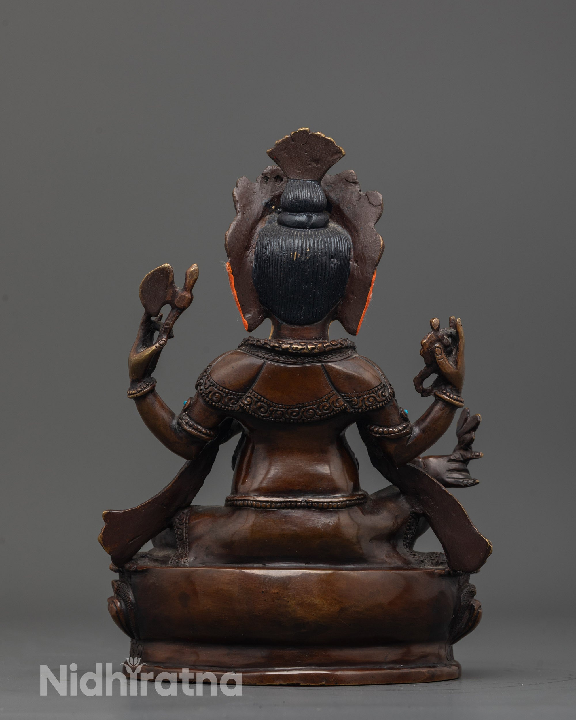 Back view of handcrafted Lord Ganesha statue highlighting rat vehicle and detailed robe