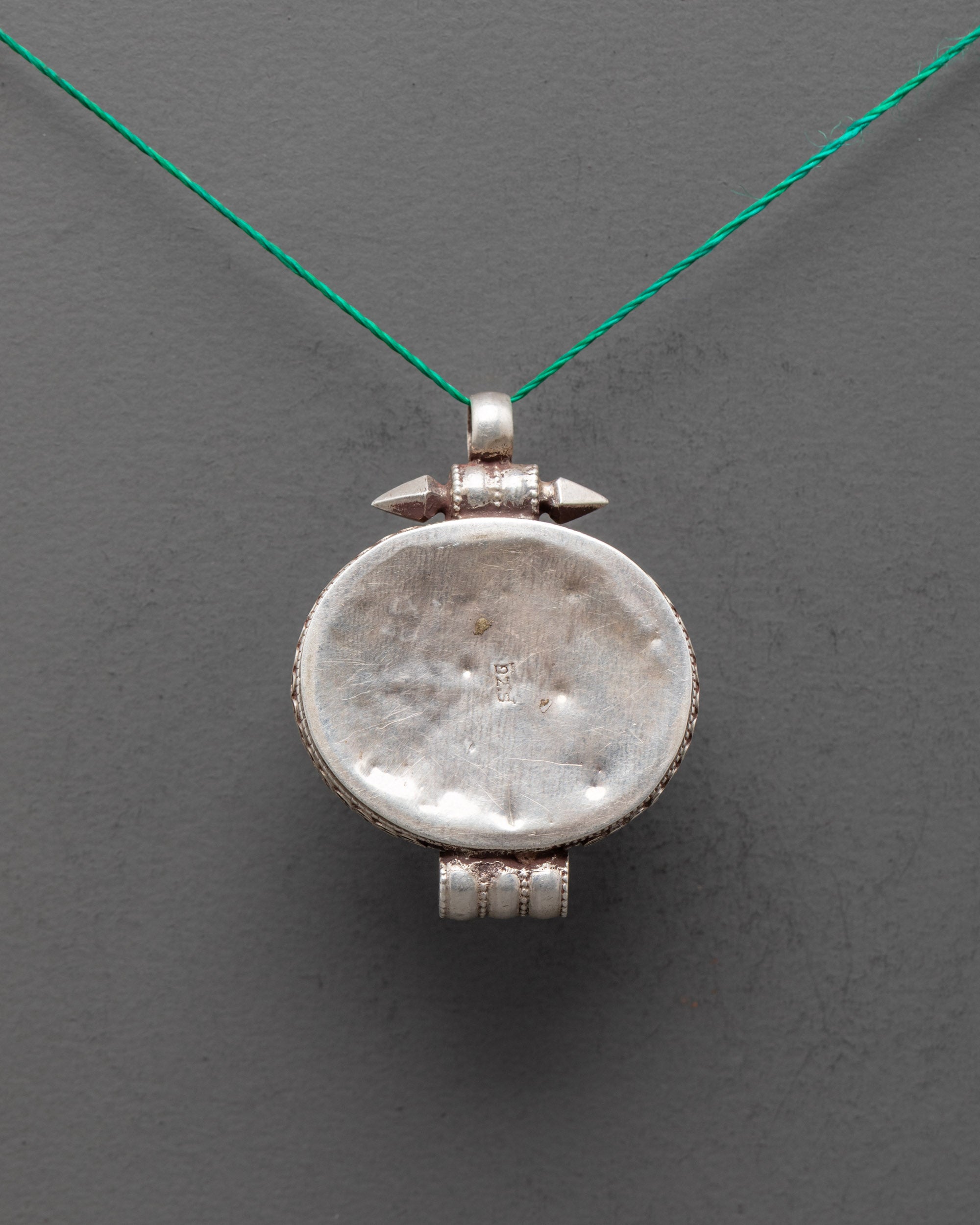 Back view of handcrafted silver locket pendant with detailed Tibetan craftsmanship