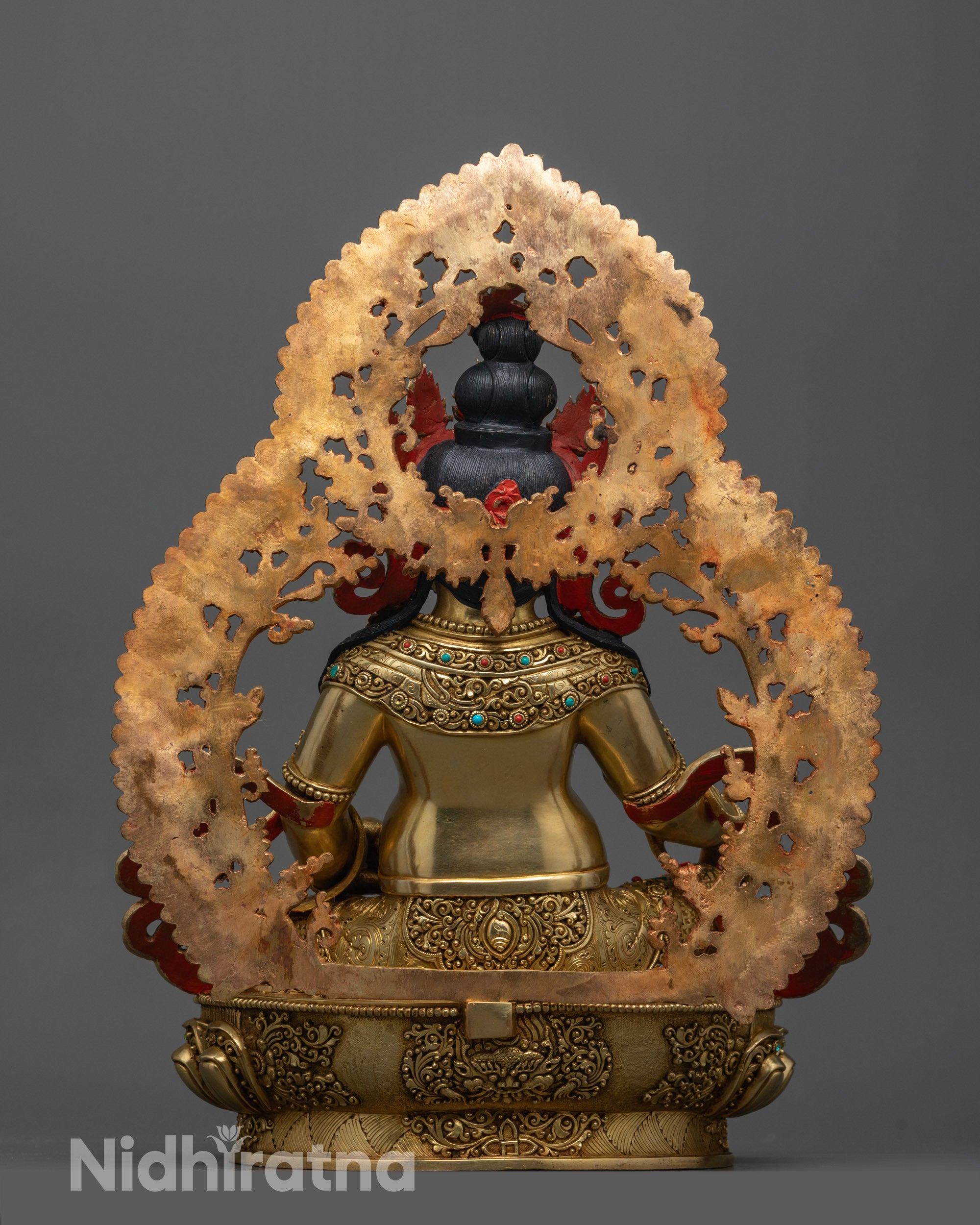 Back view of handmade Dzambhala Statue with lotus base, radiant gold finish