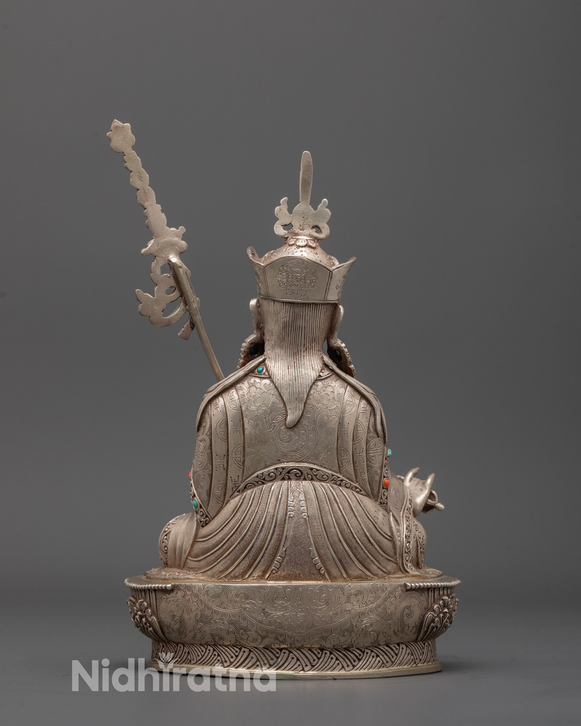 Back view of handmade Guru Rinpoche statue showing robe patterns and mantra hollow section