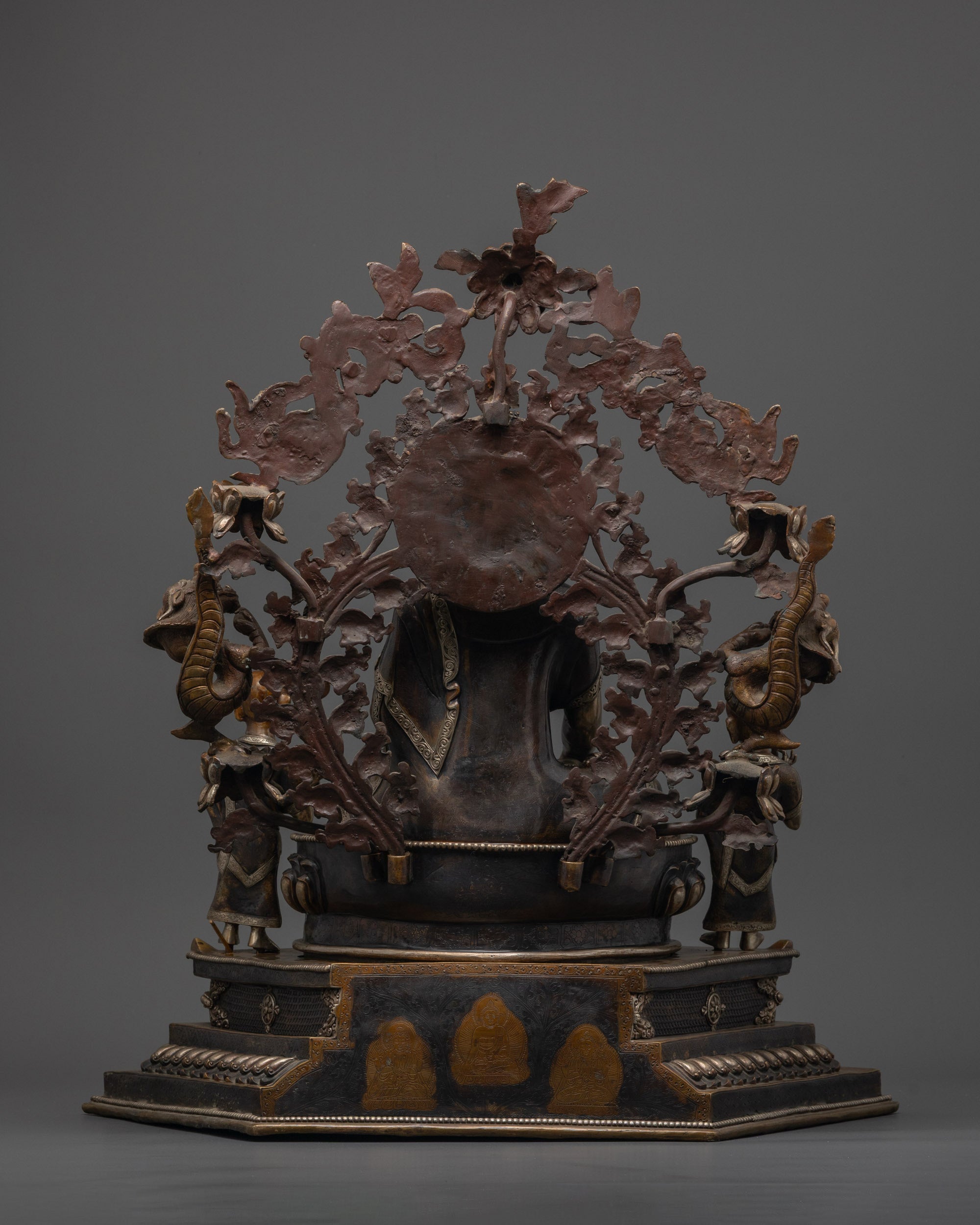 Back view of intricately carved Shakyamuni Buddha sculpture showing hollow chamber