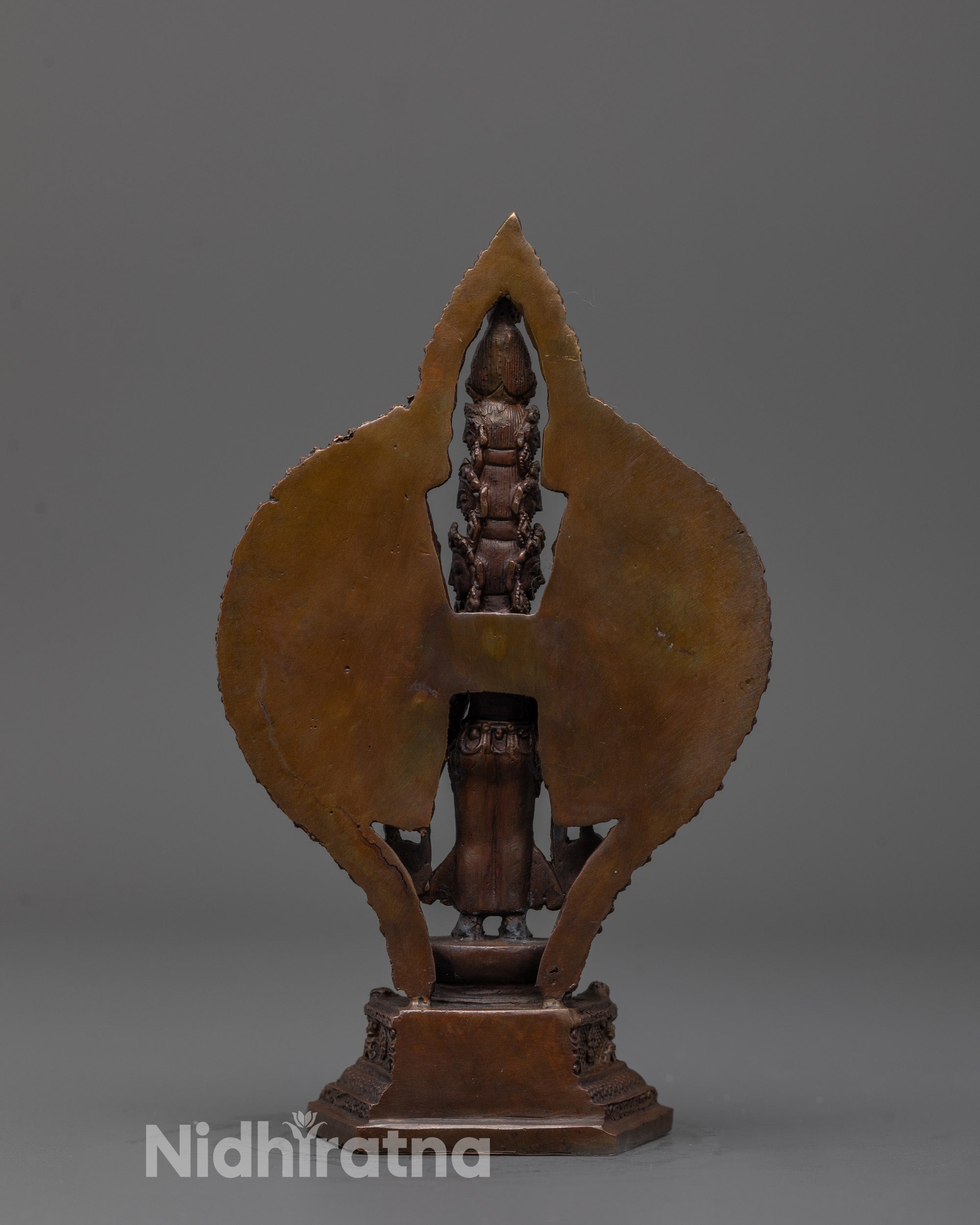 Back view of oxidized Chenrezig statue revealing engraved halo and craftsmanship details